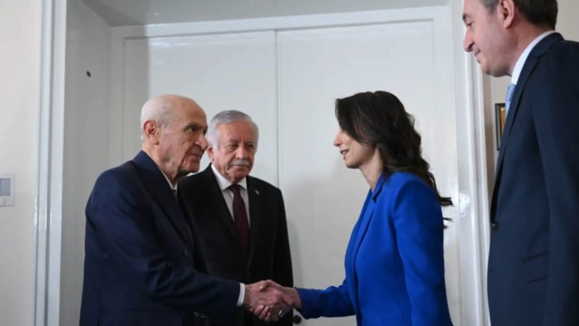 A woman shaking hands with a man in a suit. A woman shaking hands with a man in a suit.
