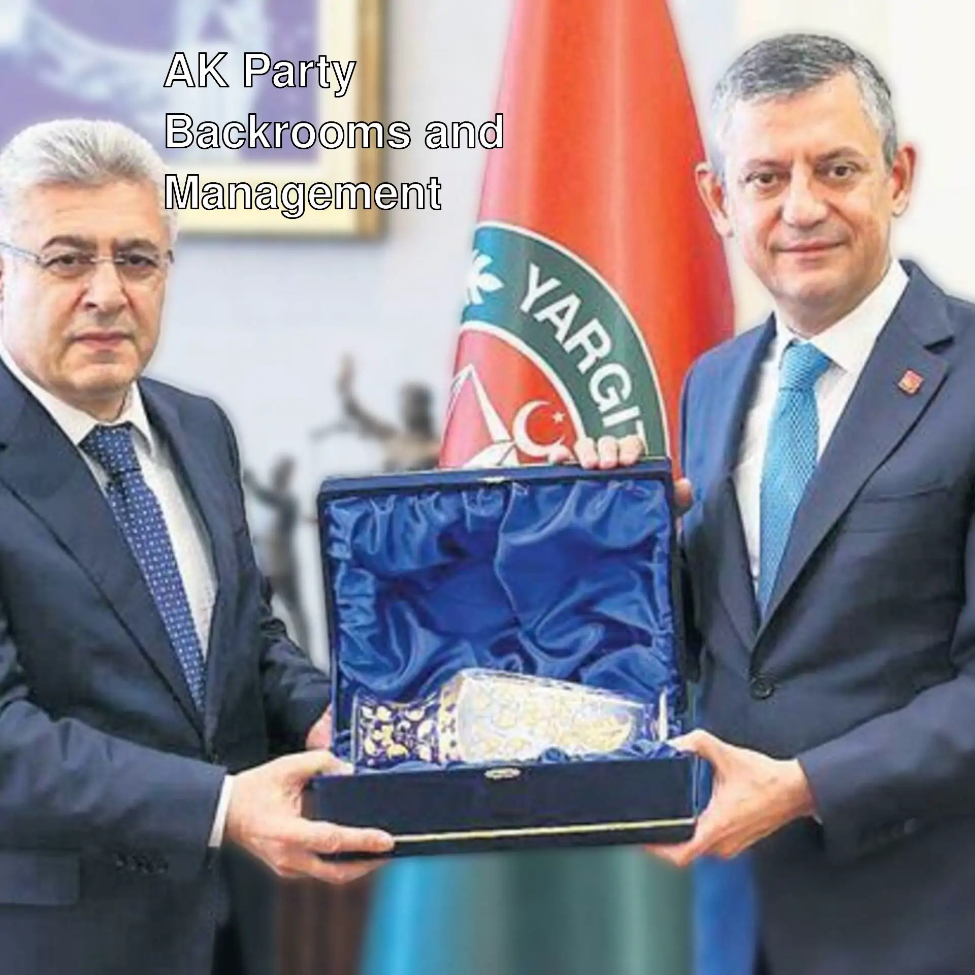 Two men in suits holding a box.