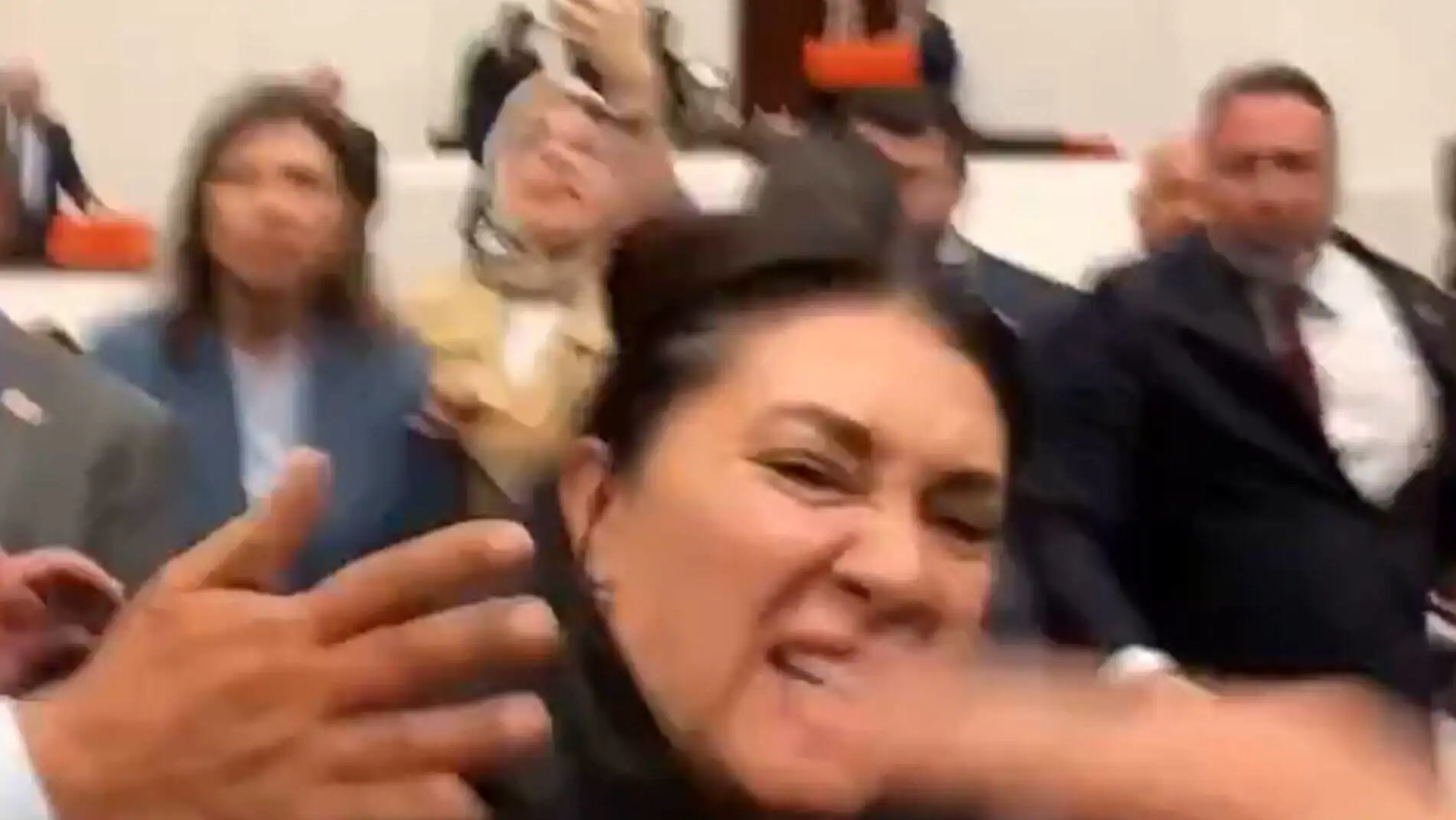 A woman yelling during the debates in Parliament. A woman yelling during the debates in Parliament.