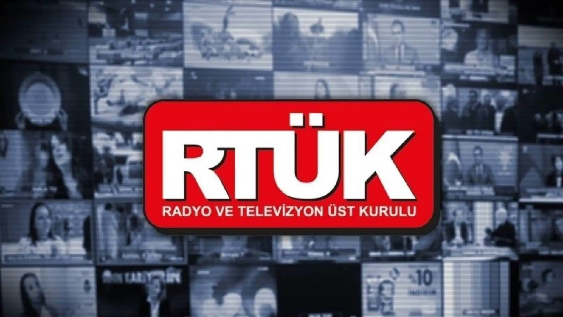 A red sign with white text. A blurry image in the background.