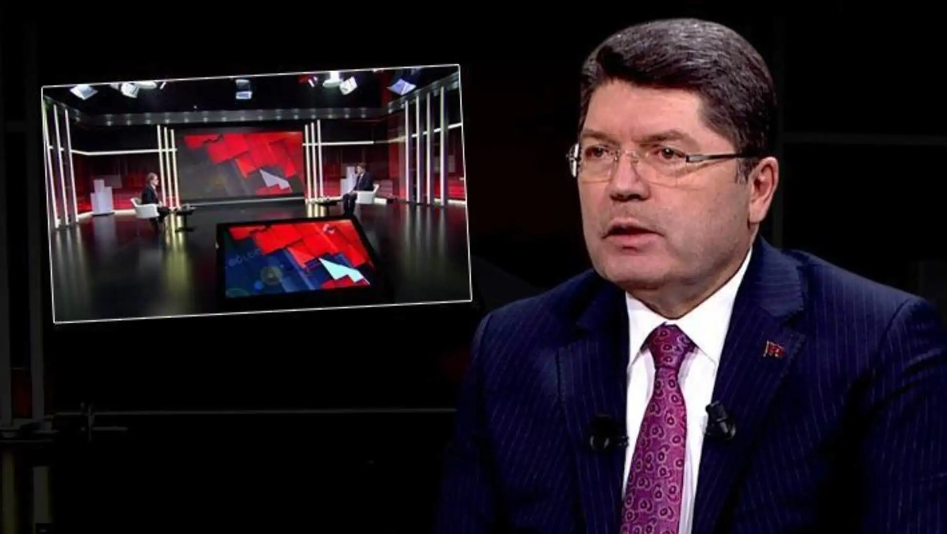 Yılmaz Tunç, Justice Minister, standing in front of a microphone.