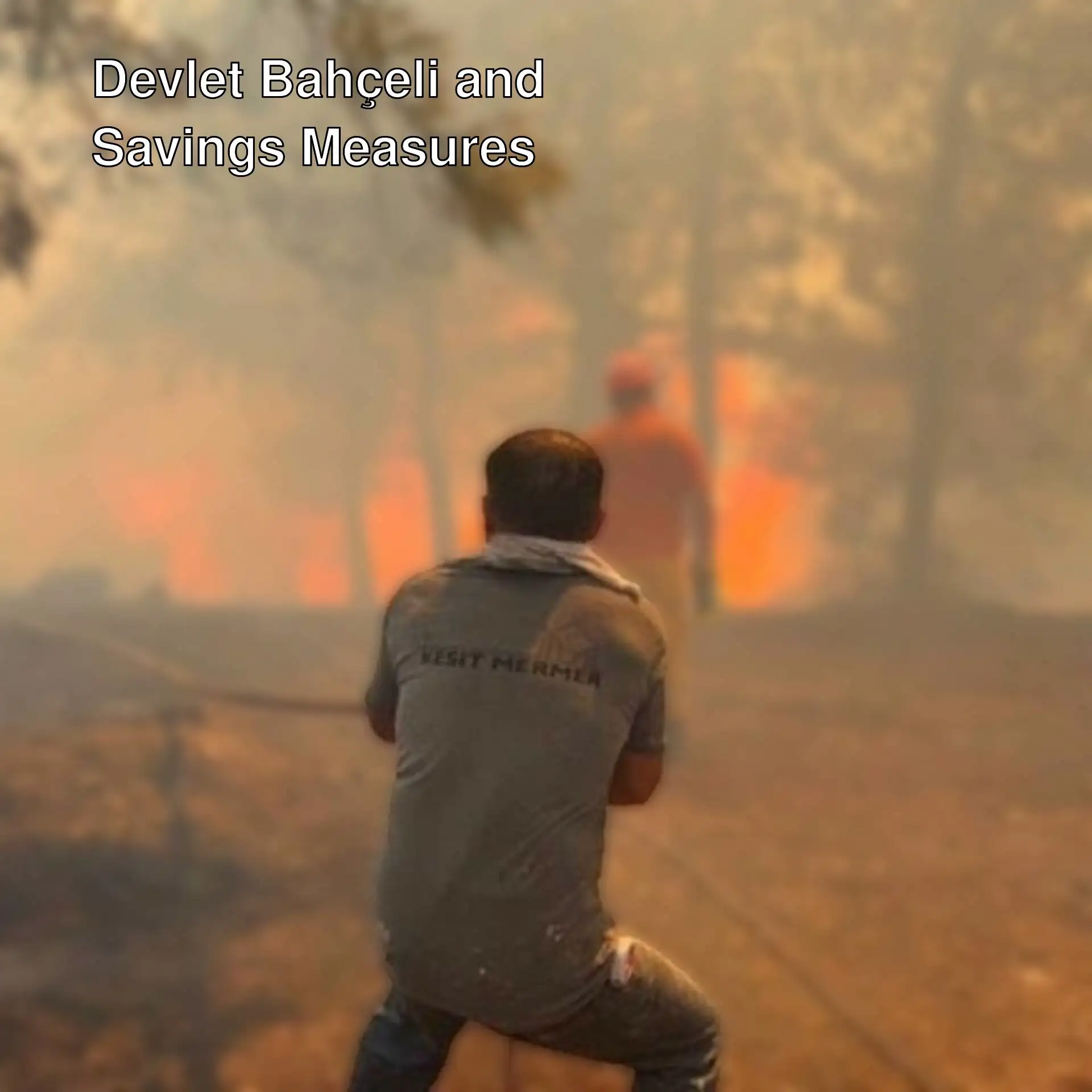 A man holding a hose while fighting a fire.