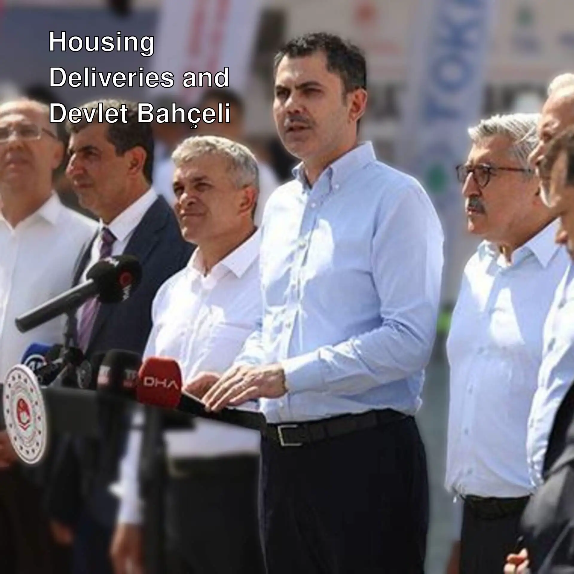 Devlet Bahçeli and Minister Kurum discussing housing deliveries in Hatay.