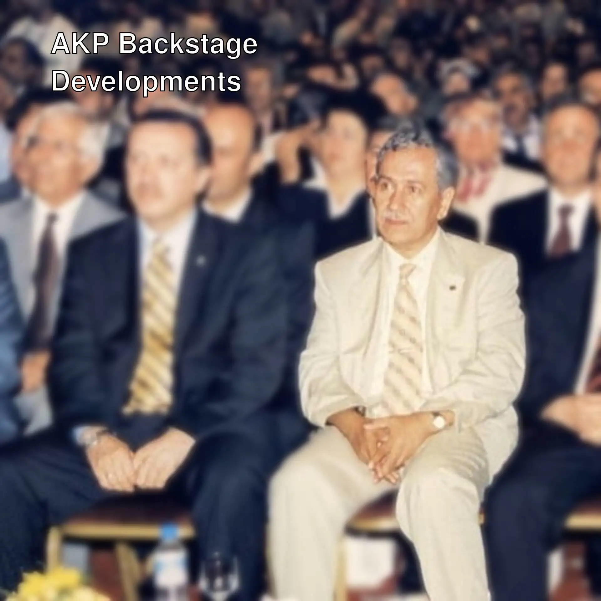 A group of men sitting in chairs in AKP backstage.