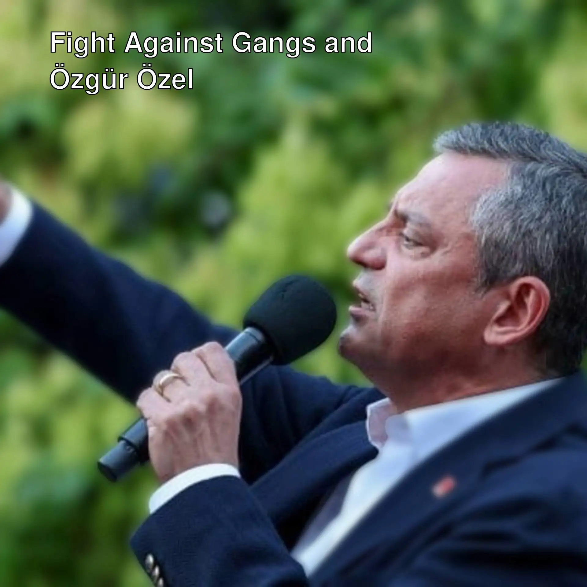 Özgür Özel speaking into a microphone. Özgür Özel speaking into a microphone.