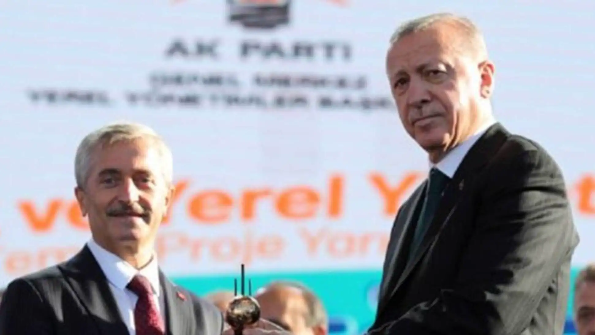 Two men in suits holding a ball Two men in suits holding a ball