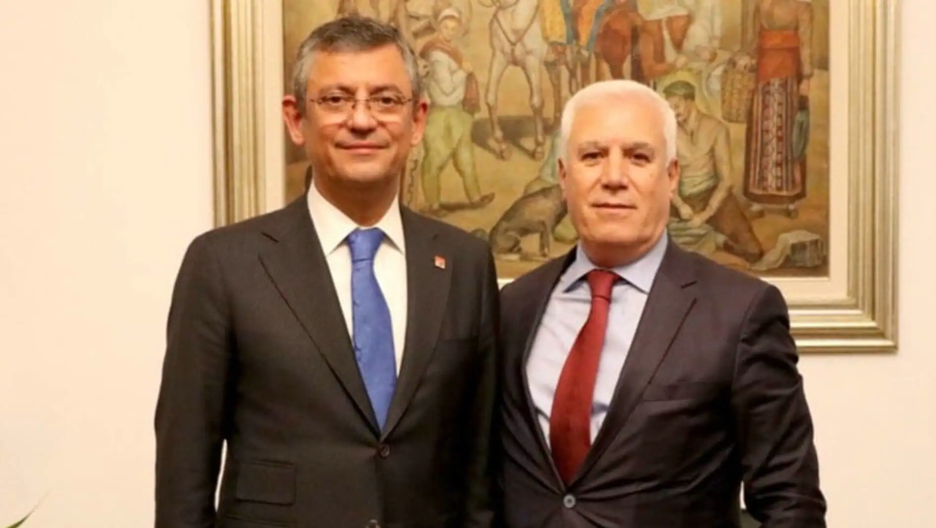 Two men in suits standing together. Two men in suits standing together.