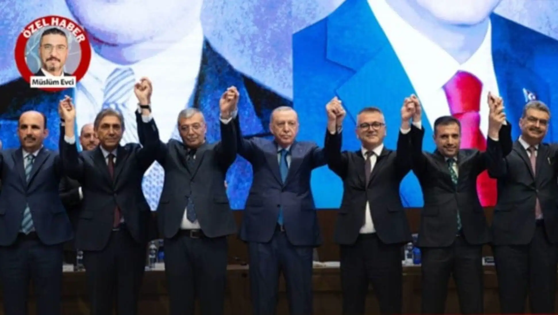 Bir grup adam takım elbise içinde ellerini kaldırıyor.