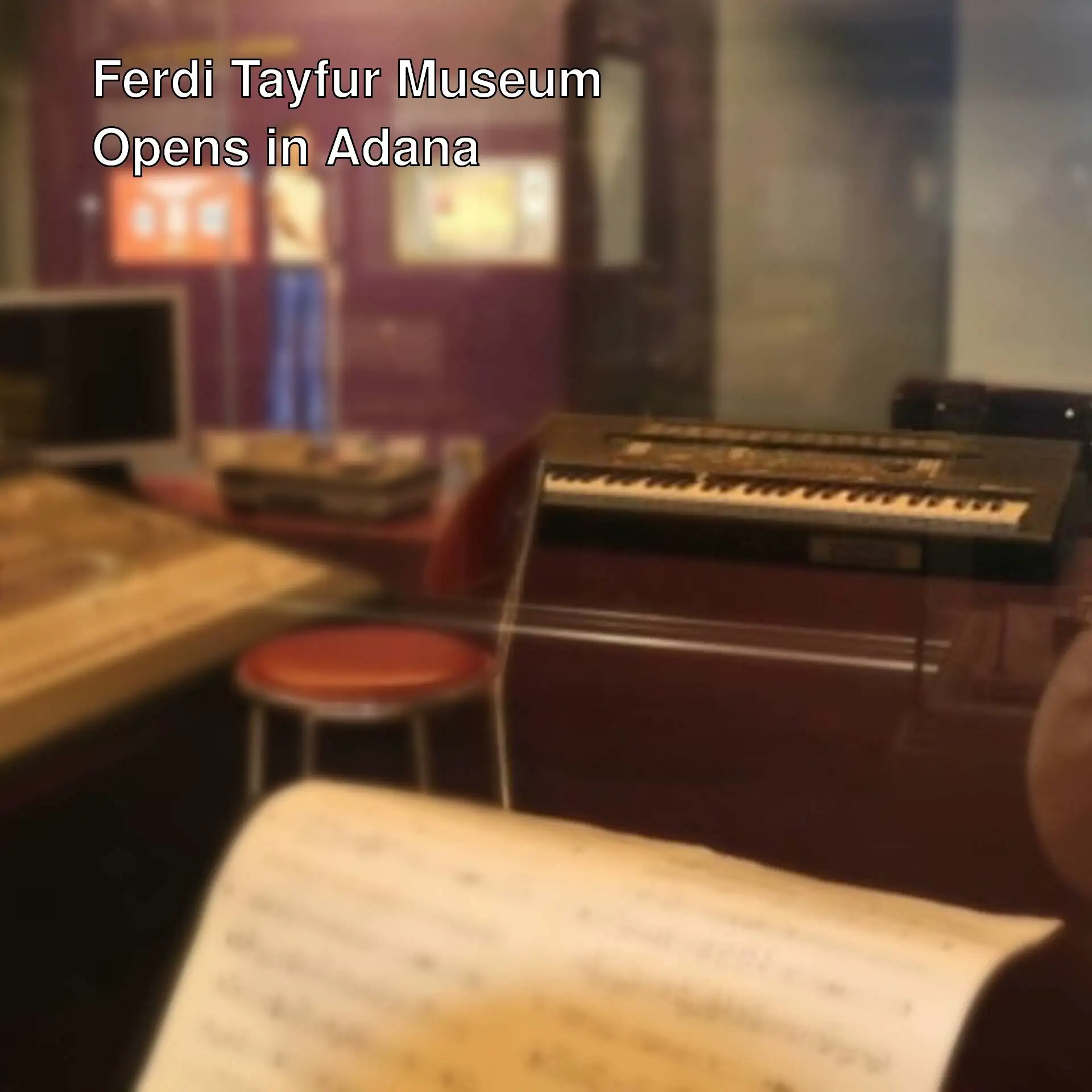 A person sitting with musical instruments at the Ferdi Tayfur Museum opening.