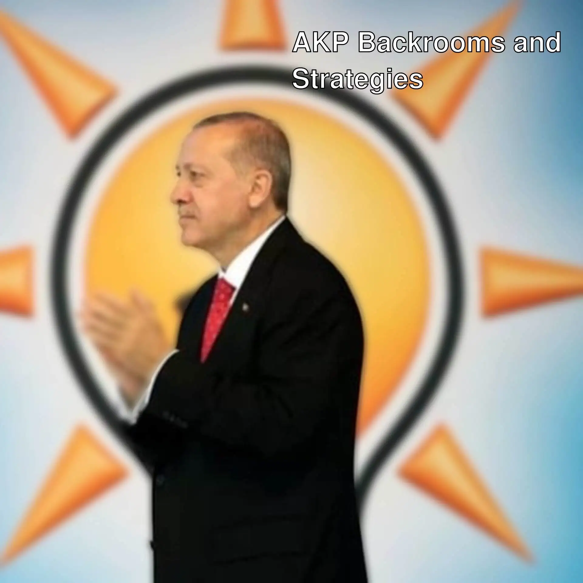 A man in a suit clapping his hands.