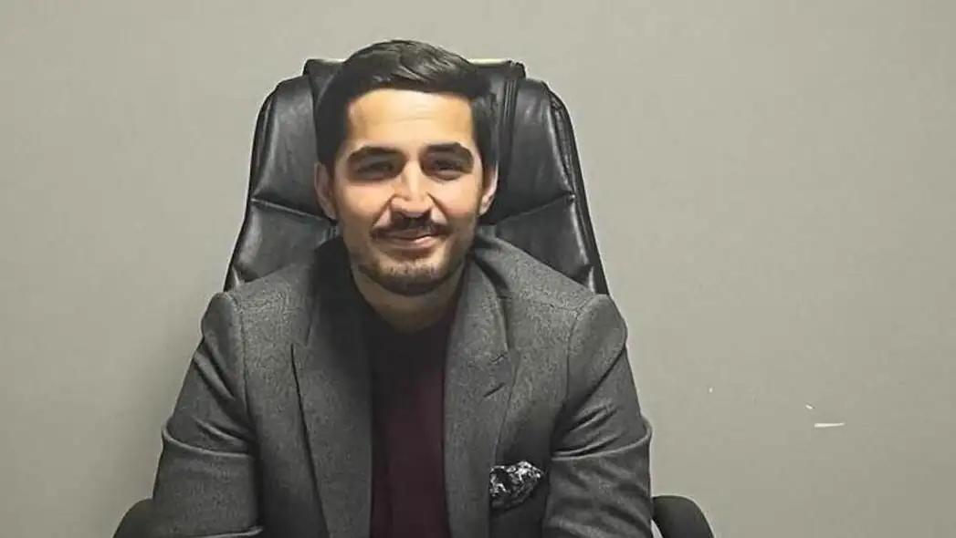 An AKP executive sitting at his desk.