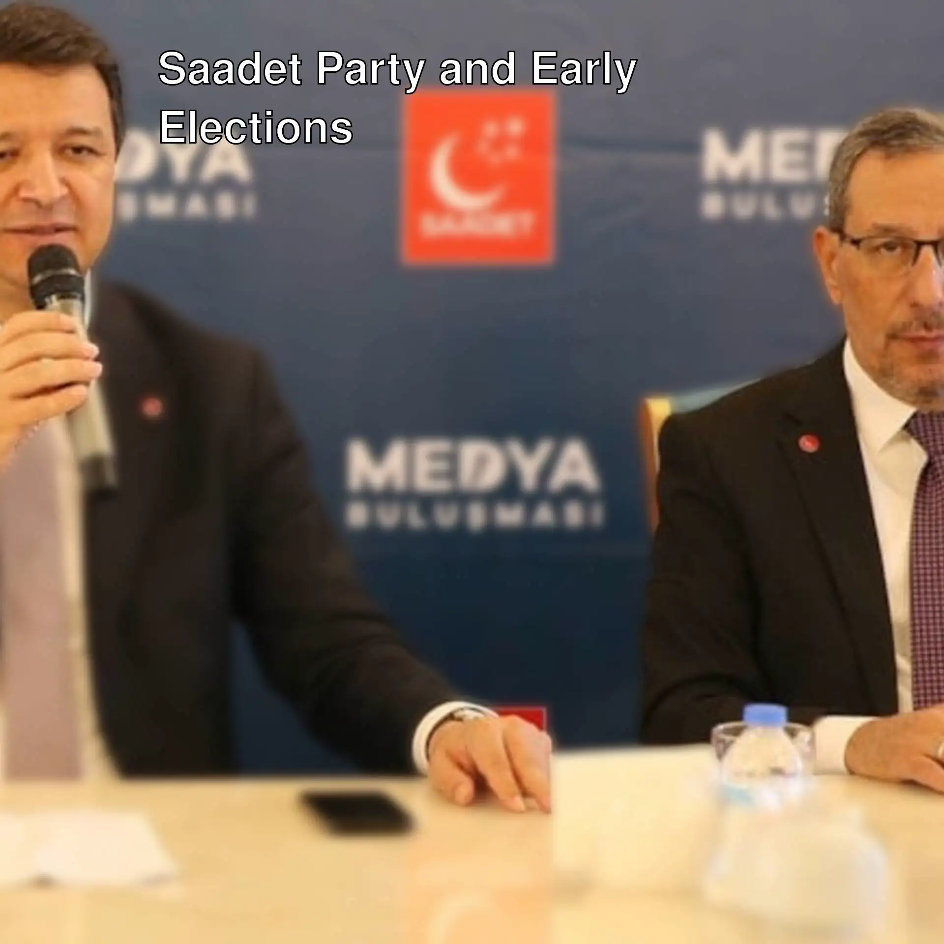 Mahmut Arıkan and another person at a meeting.