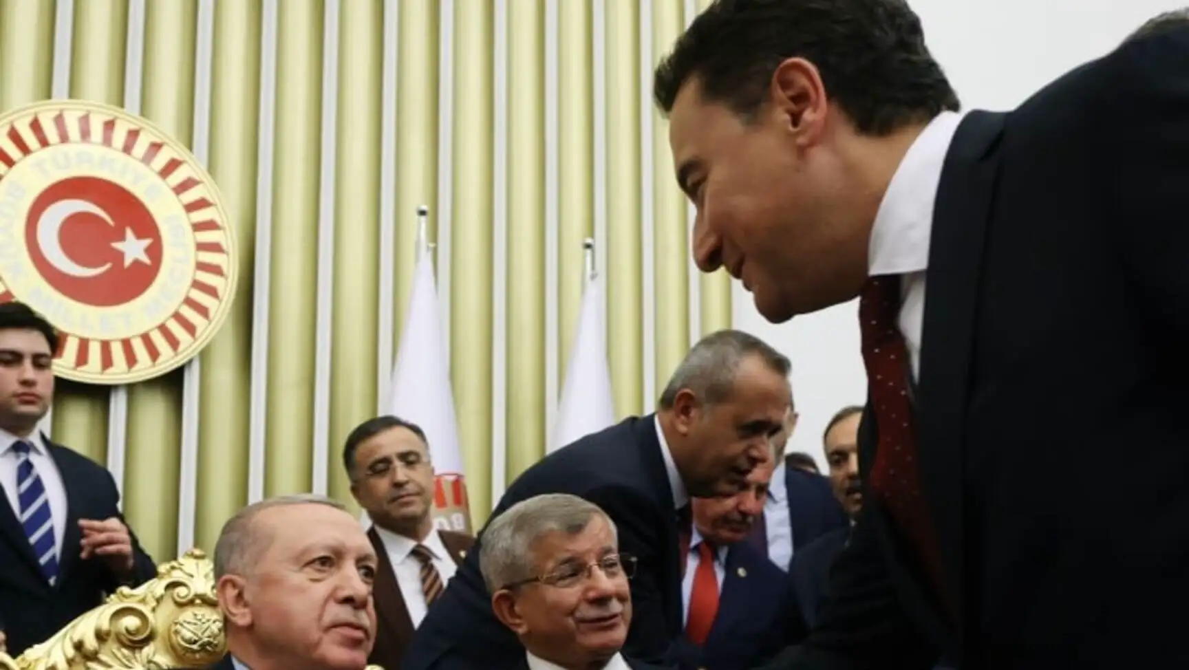 President Erdoğan shaking hands with Davutoğlu and Babacan.