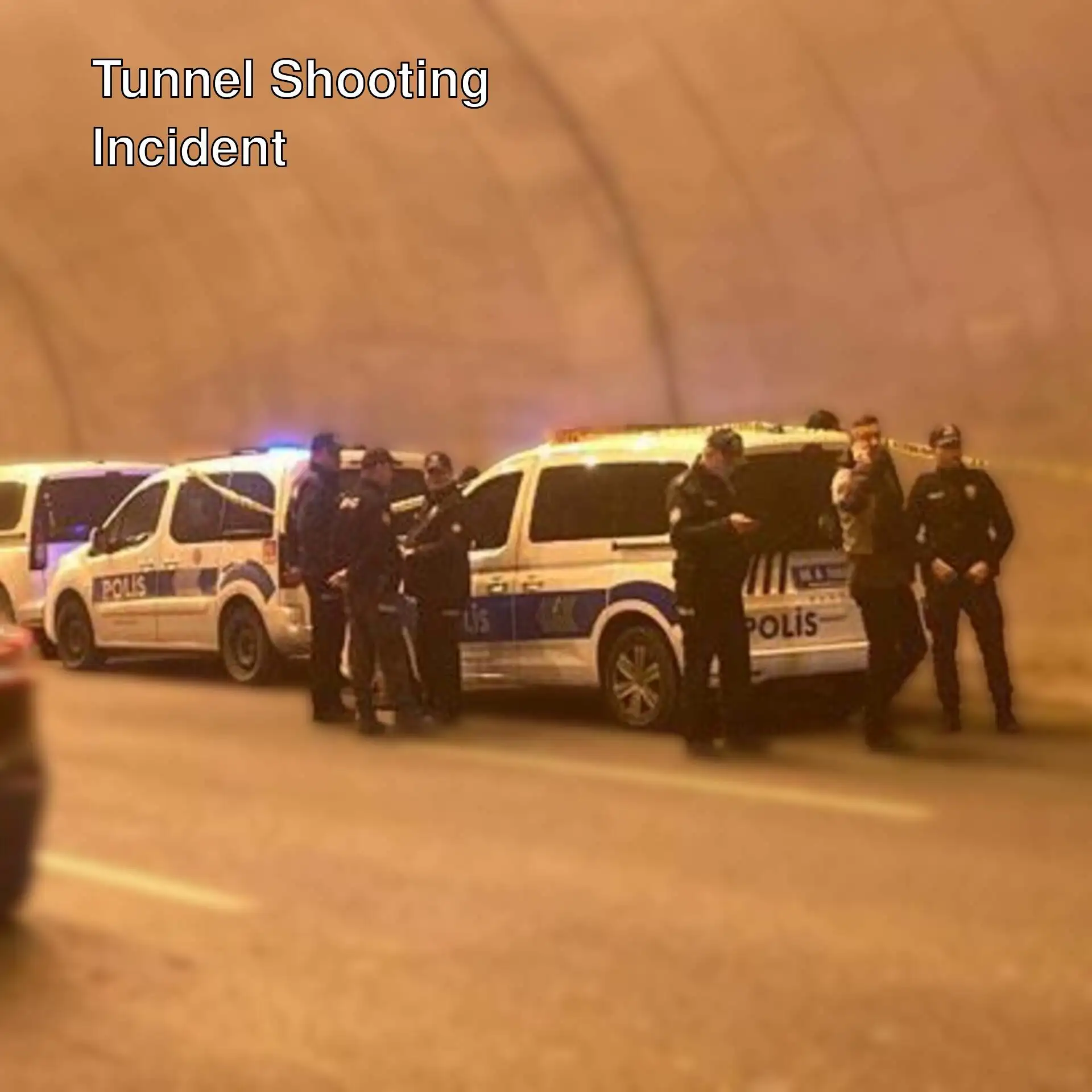 Police officers standing in a tunnel.