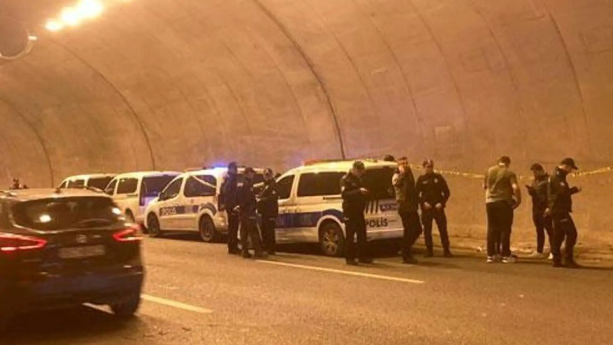 A group of police officers standing in a tunnel.