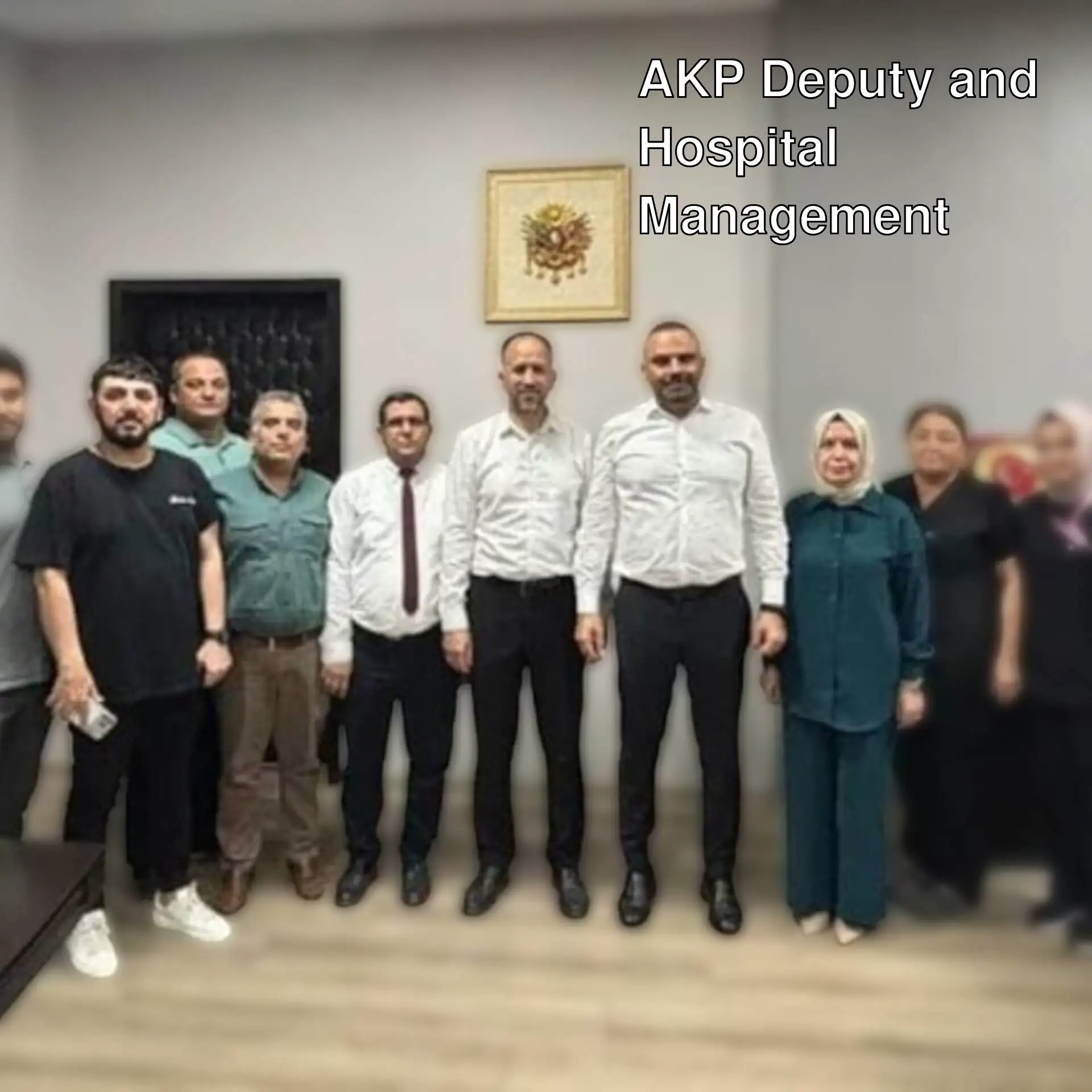 A group of people standing in a room. A group of people standing in a room.