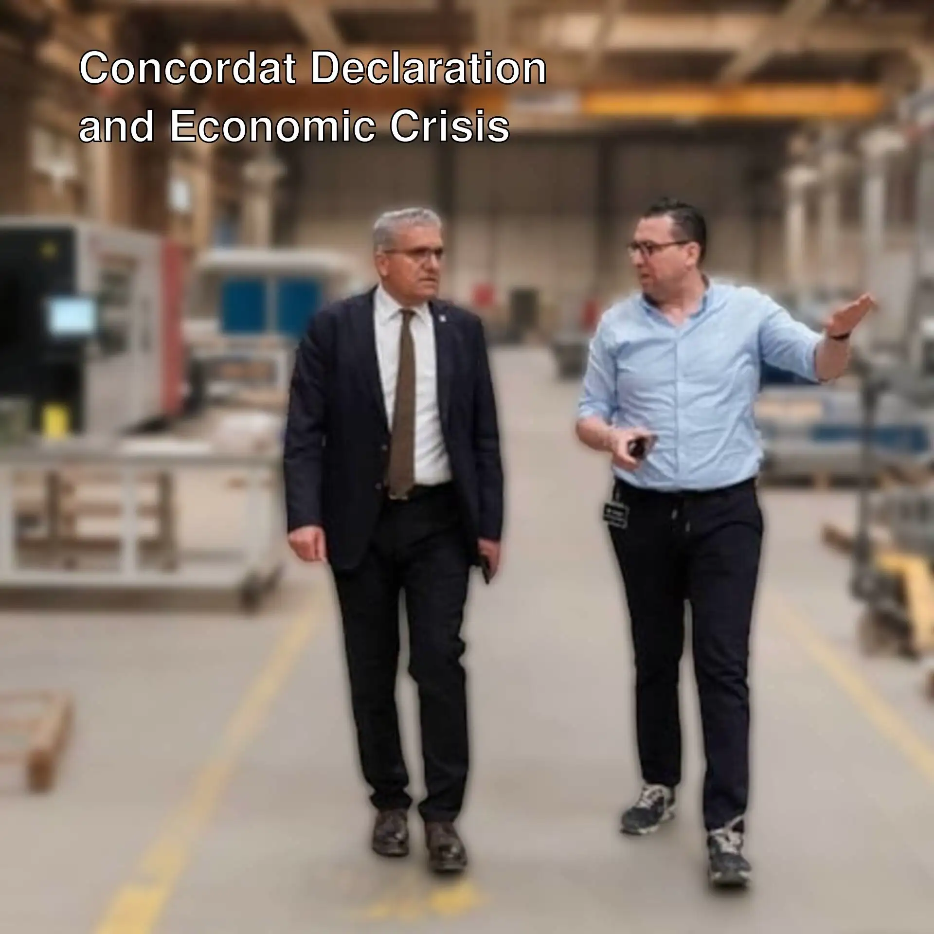 Two men walking in a factory. Two men walking in a factory.