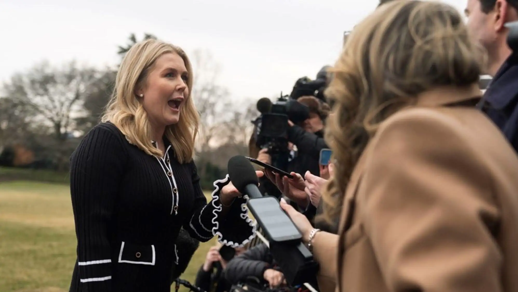 A woman speaking into a microphone. A woman speaking into a microphone.