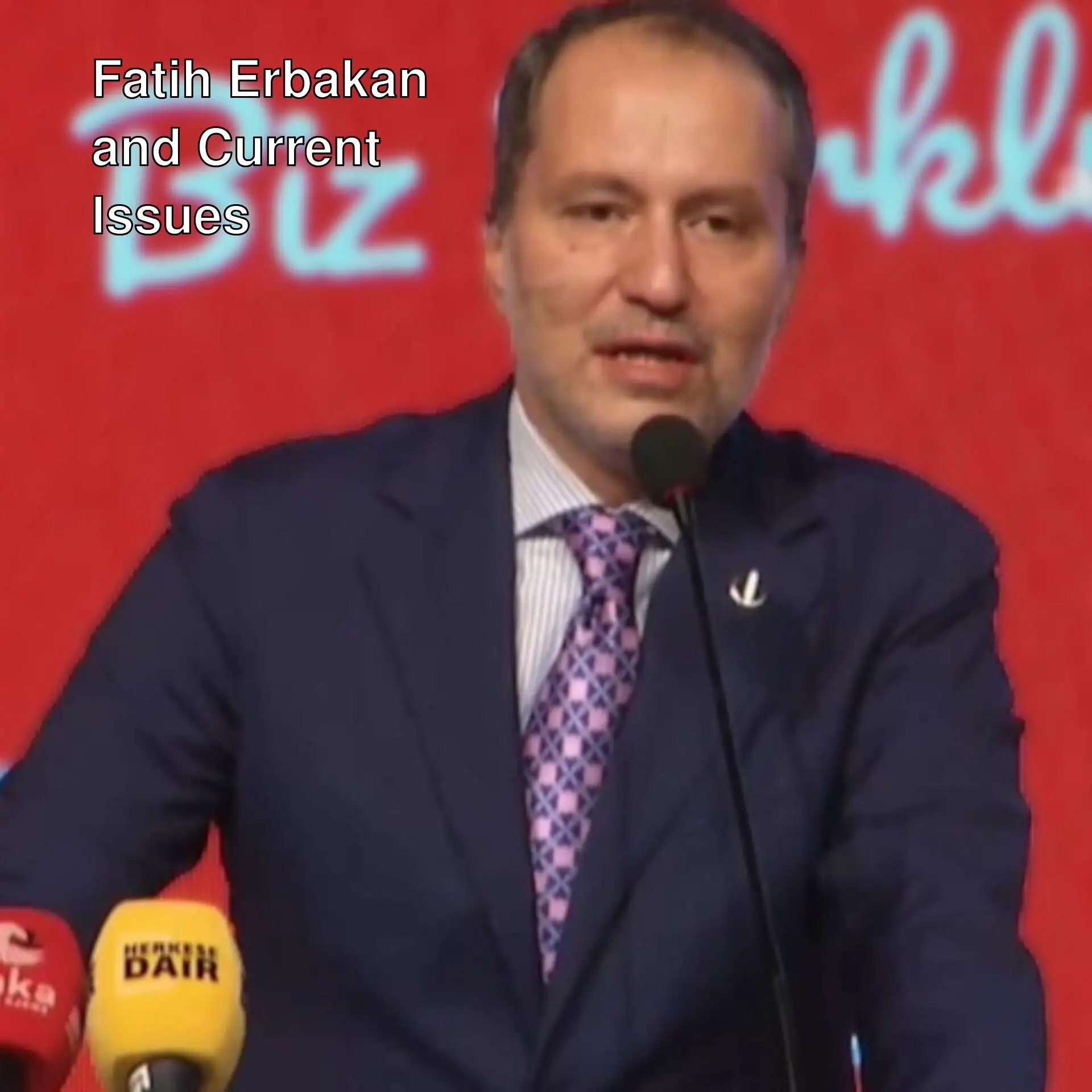 Fatih Erbakan speaking into a microphone. Fatih Erbakan speaking into a microphone.