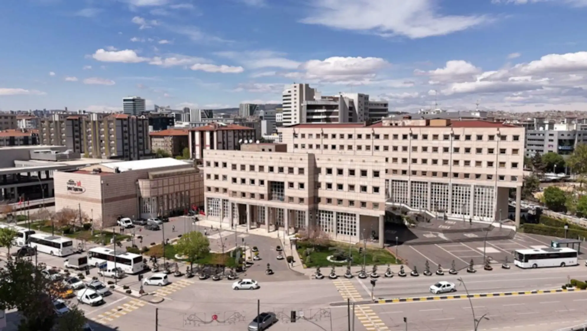 A large building with cars parked in a street.