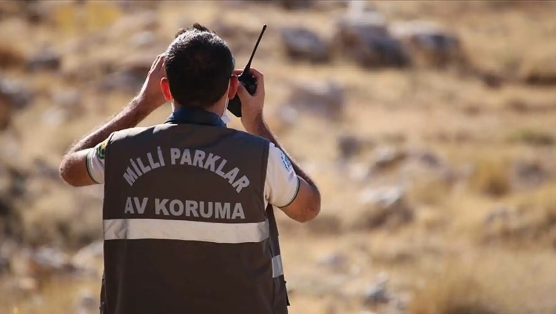 A man holding a walkie talkie.