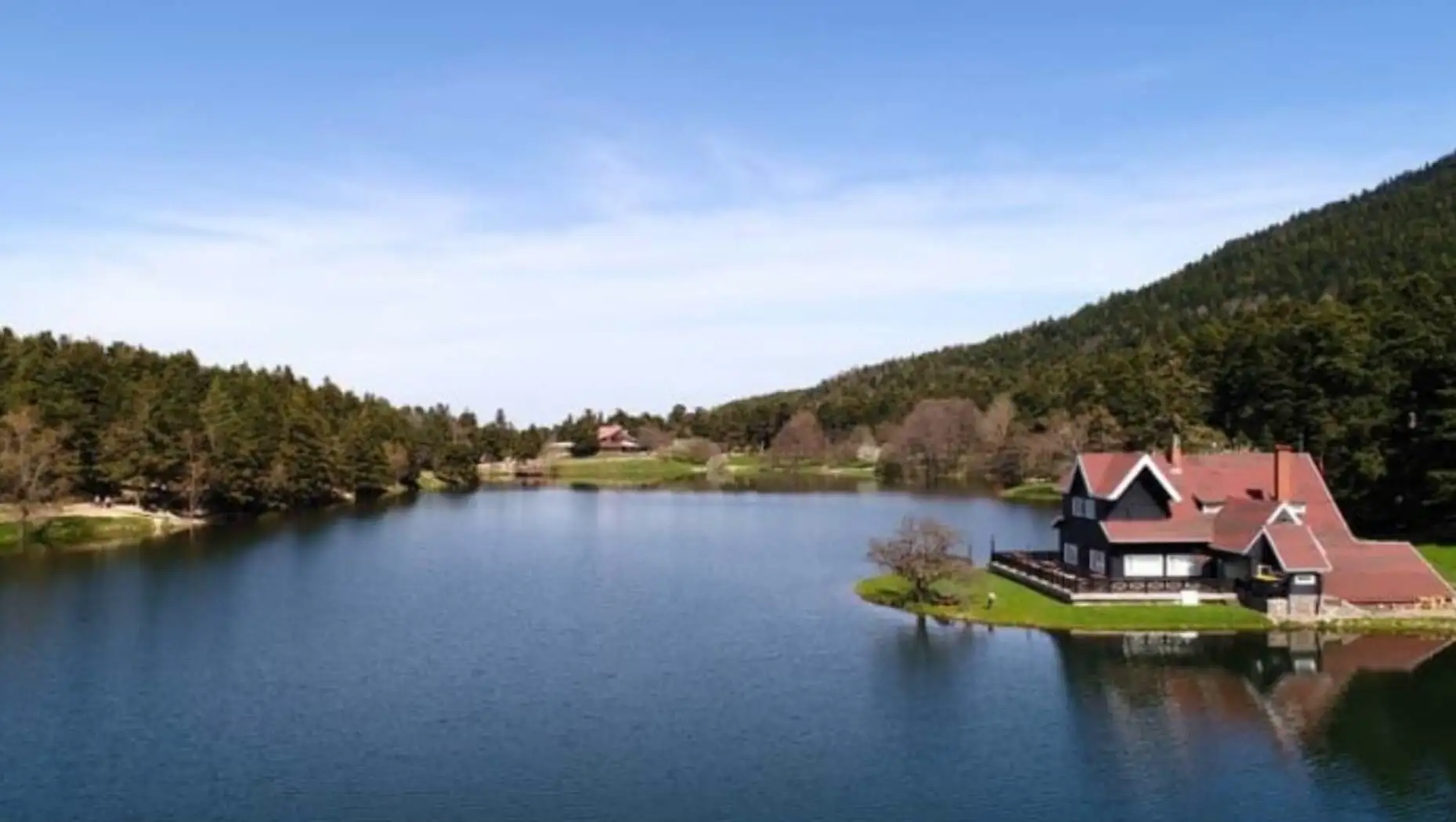 A house on a small island surrounded by water.