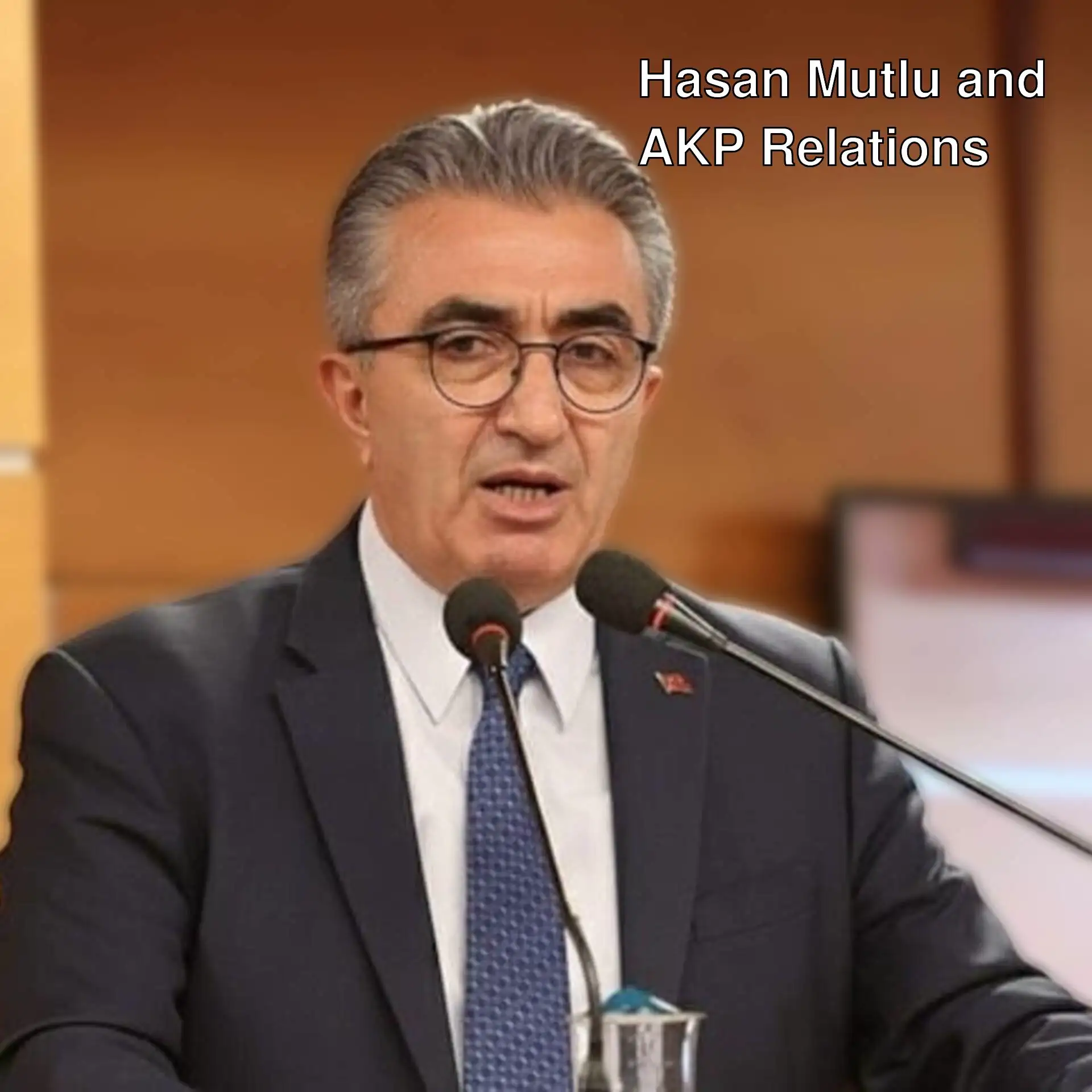 Hasan Mutlu speaking into a microphone.