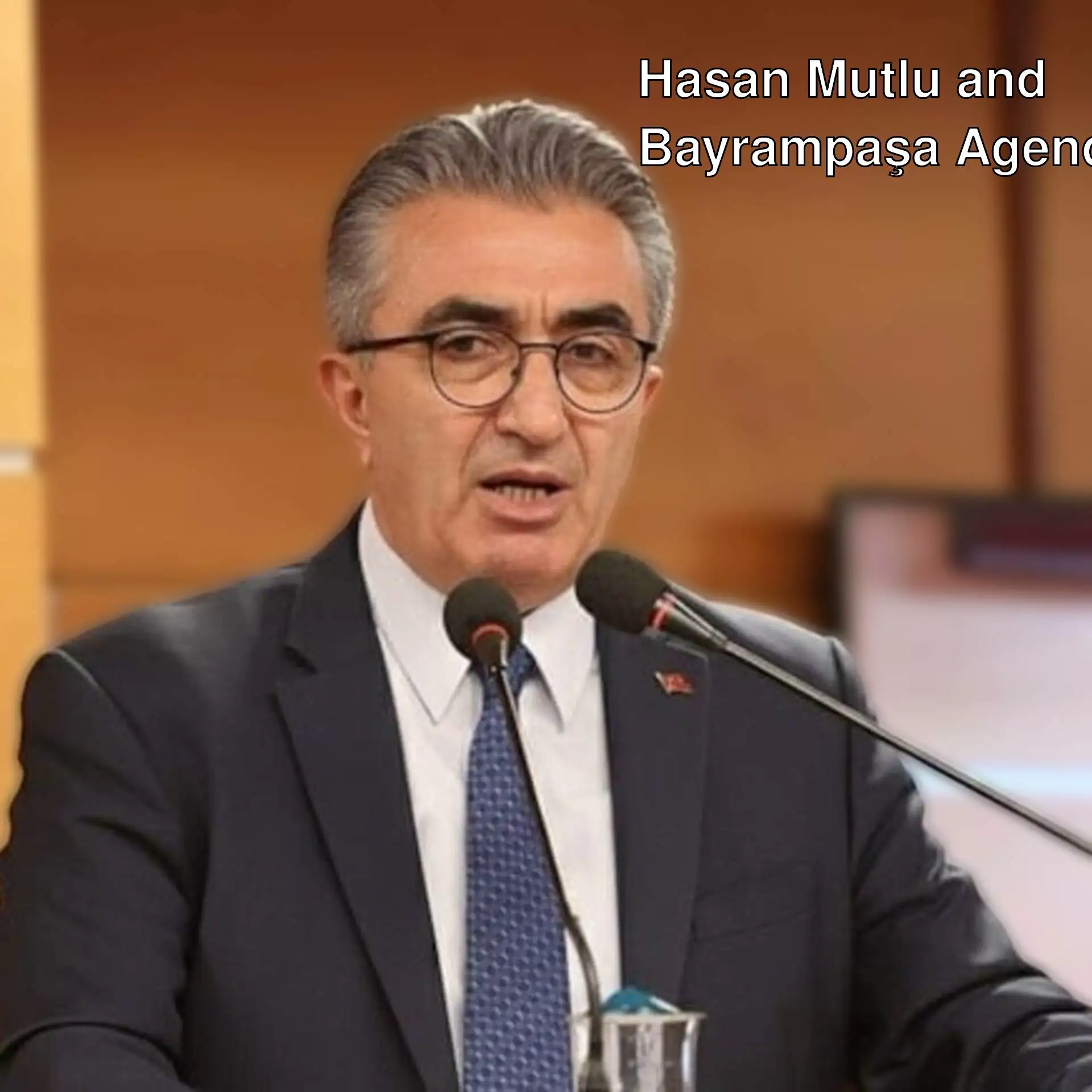 Hasan Mutlu speaking into a microphone.