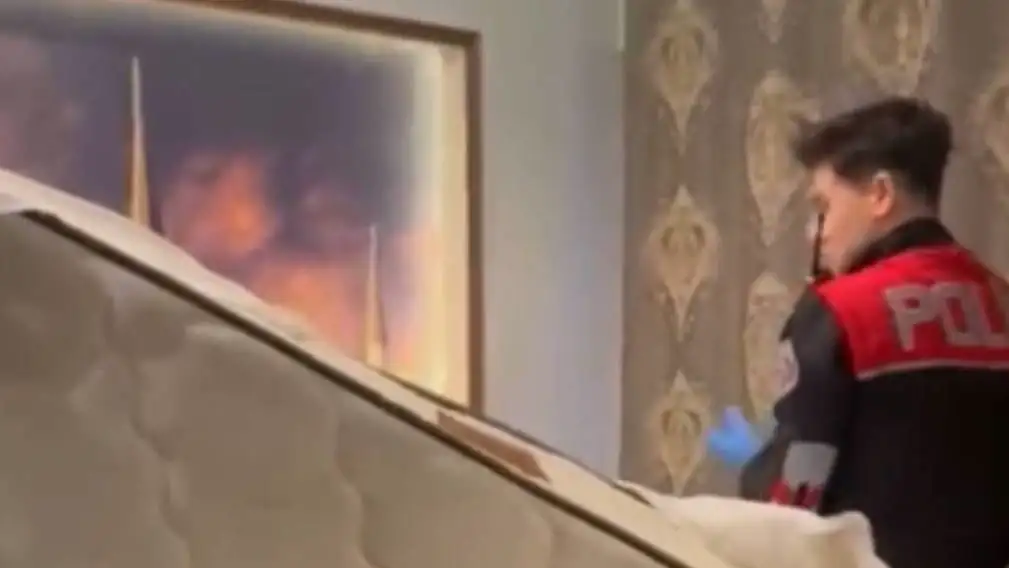 Police conducting a raid in the hotel room.