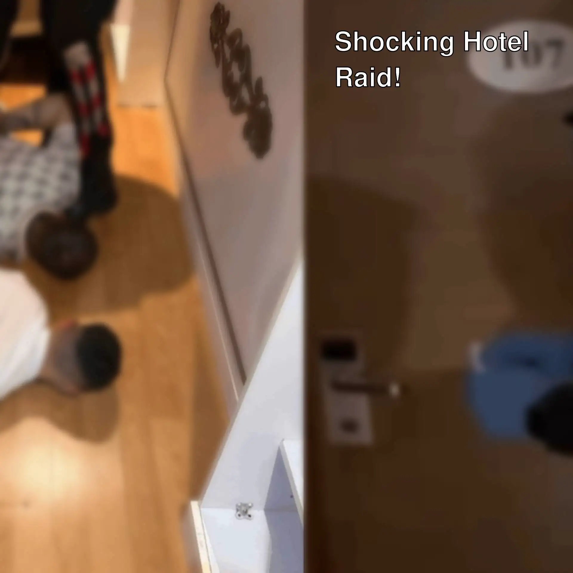 A man lying on the floor in a hotel room.