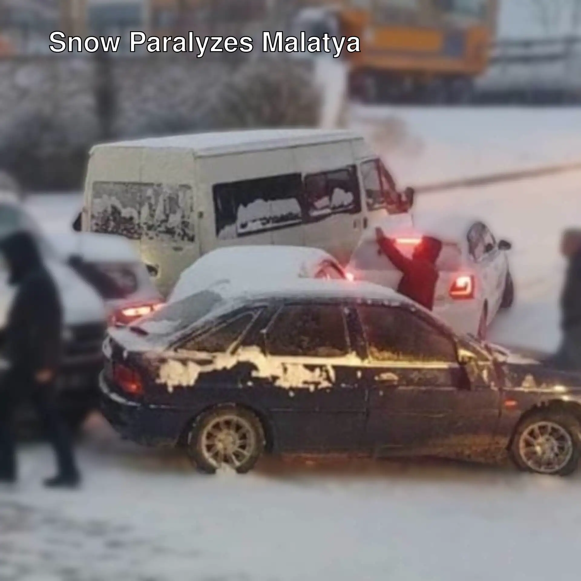 People standing around cars in the snow in Malatya. People standing around cars in the snow in Malatya.