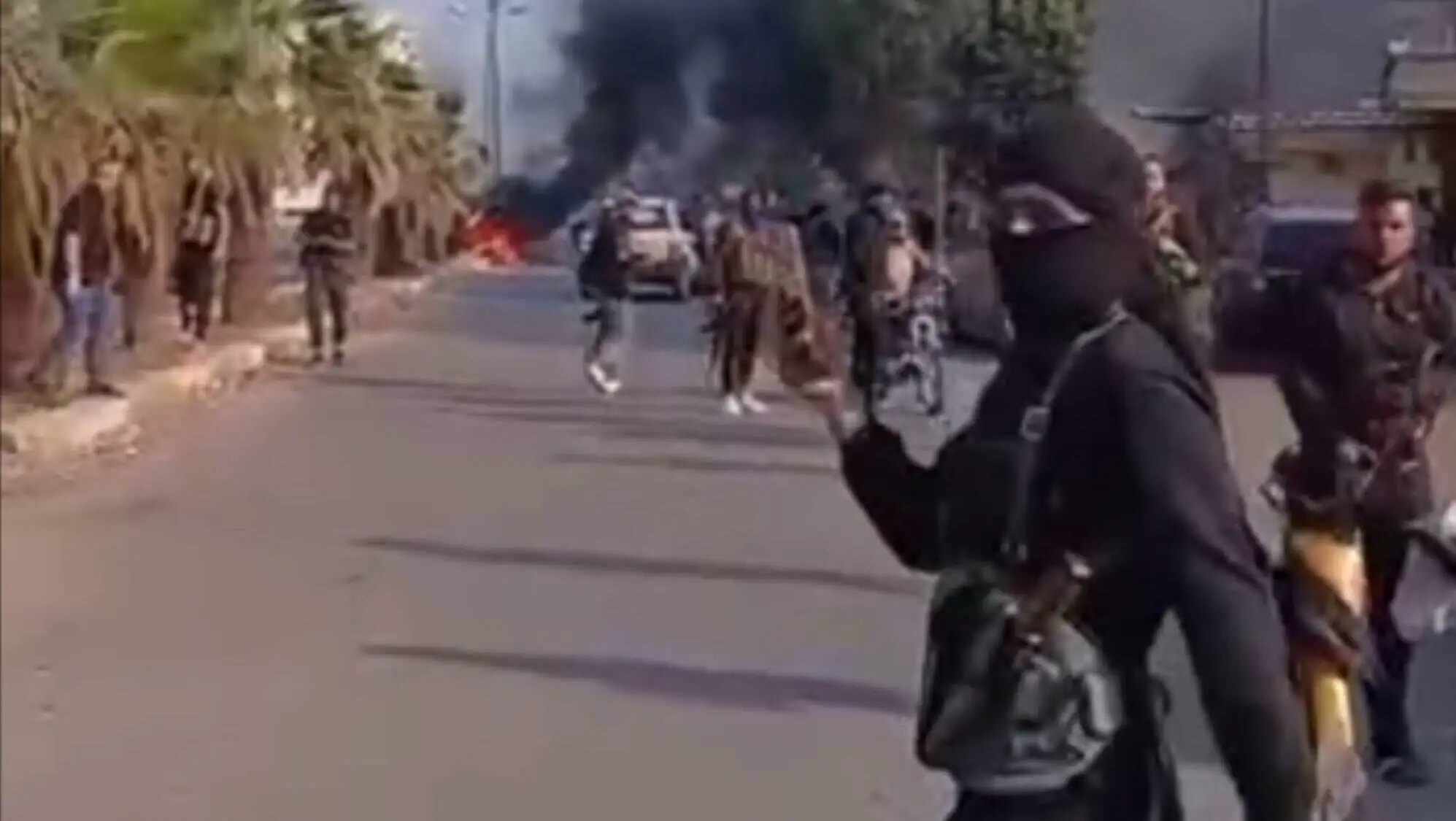 An image of a masked person among a group of people on the street.