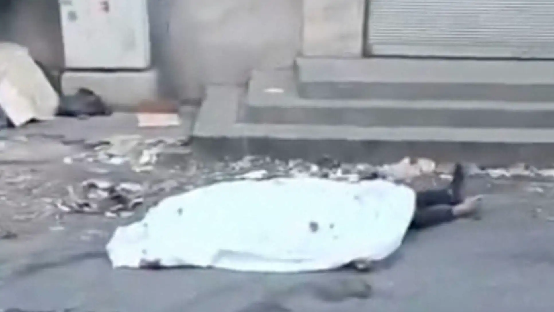 An image of a person lying on the ground, illustrating the brutality of the conflicts.