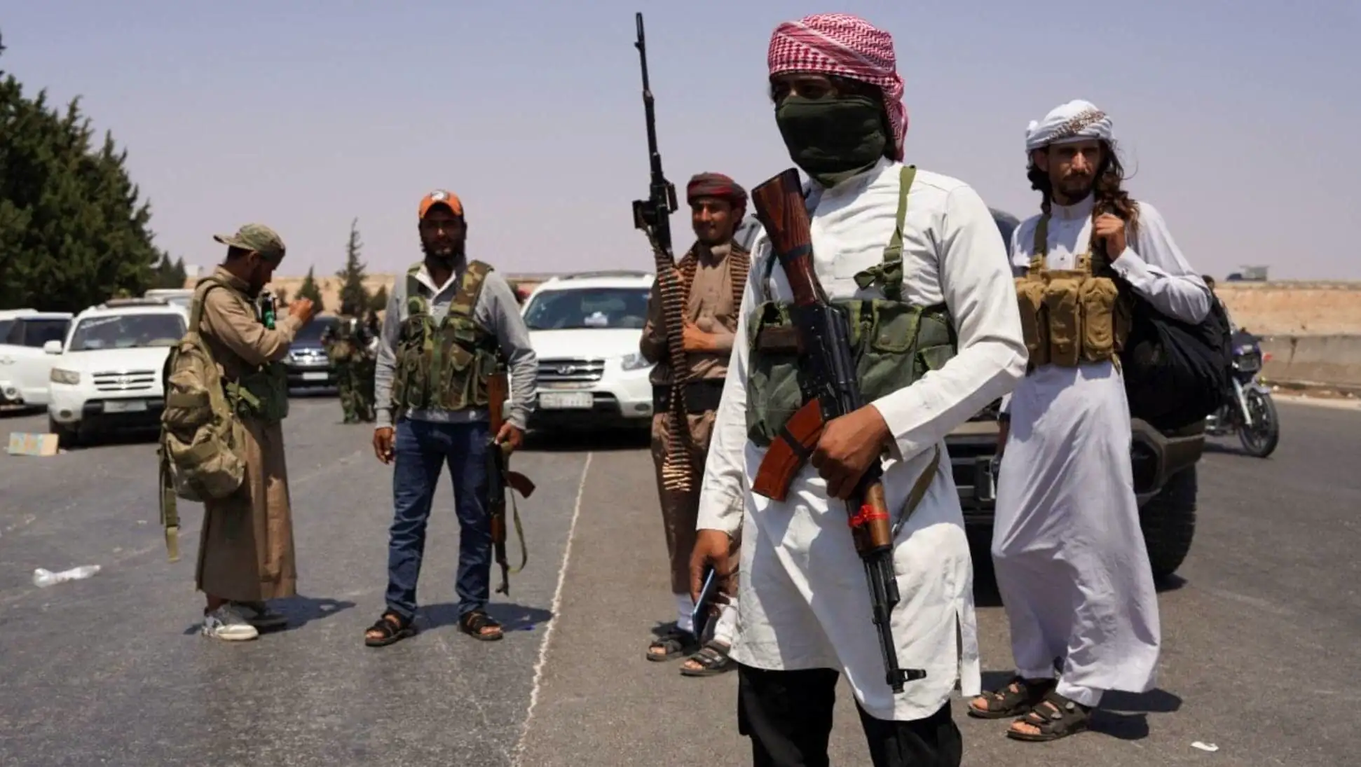A group of men with guns. A group of men with guns.