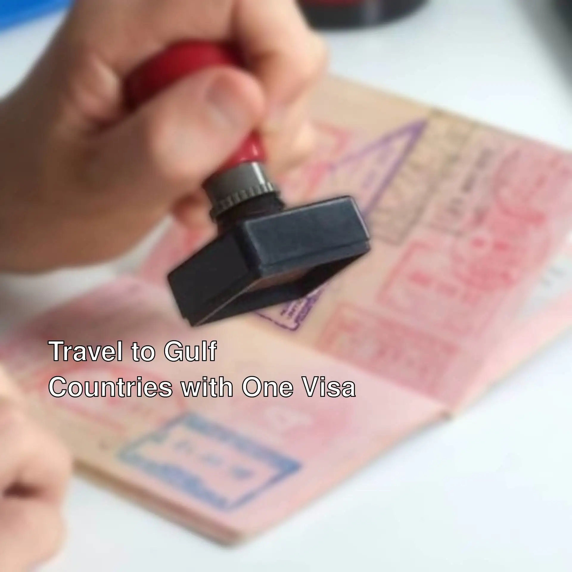 A person holding a stamp over a passport. A person holding a stamp over a passport.