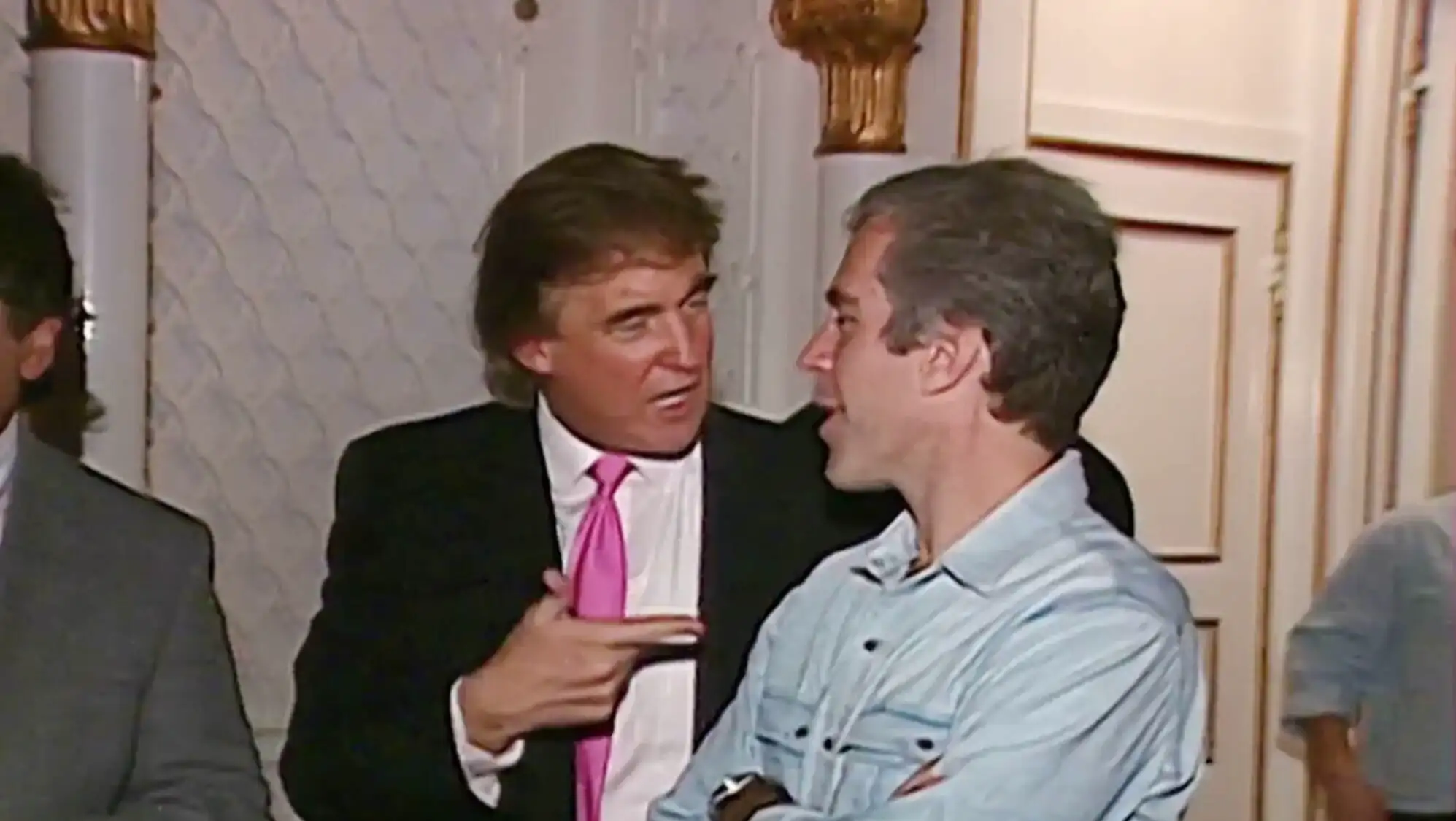 Trump pointing at another man.
