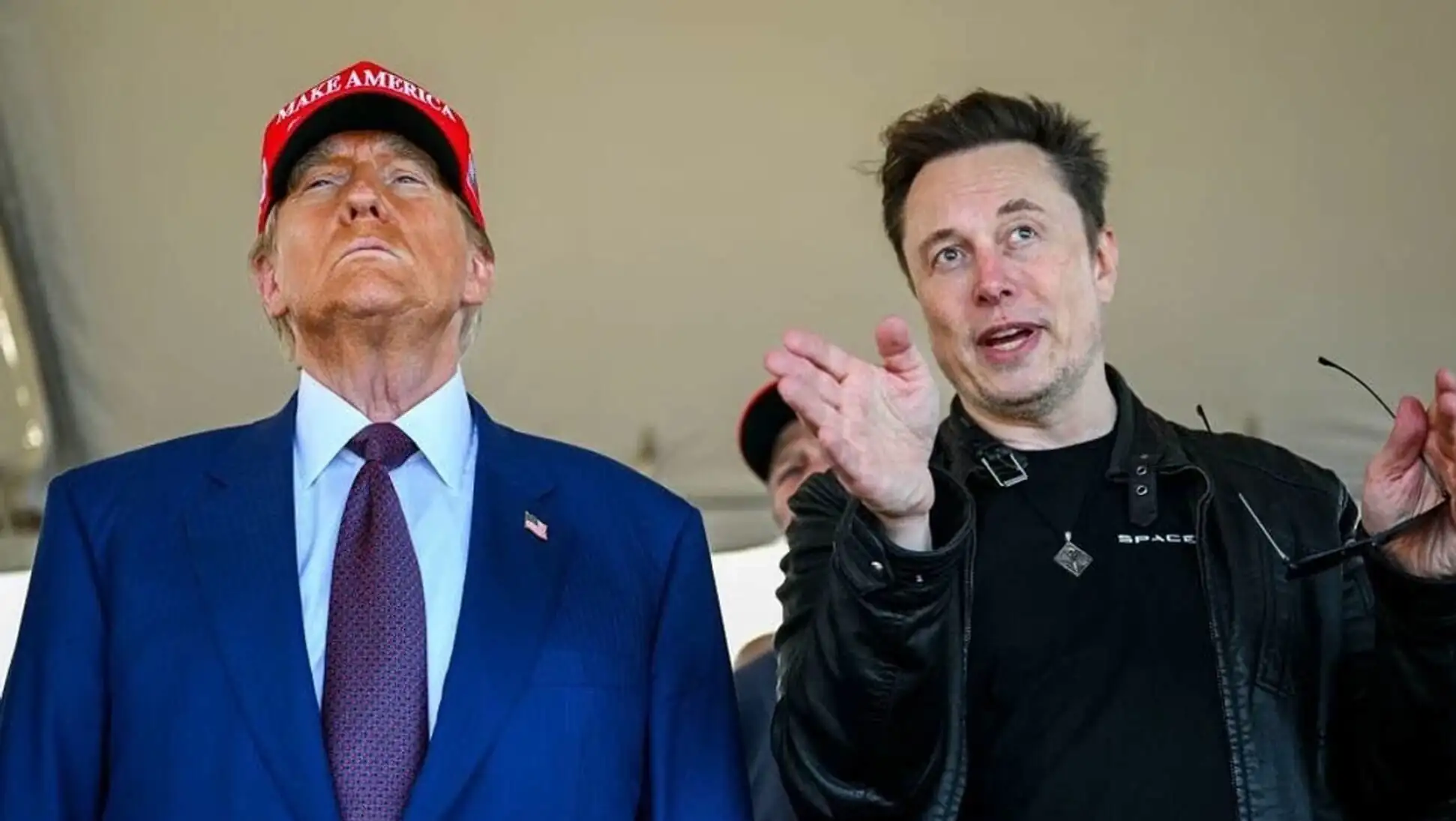 Trump in a red hat at an event.