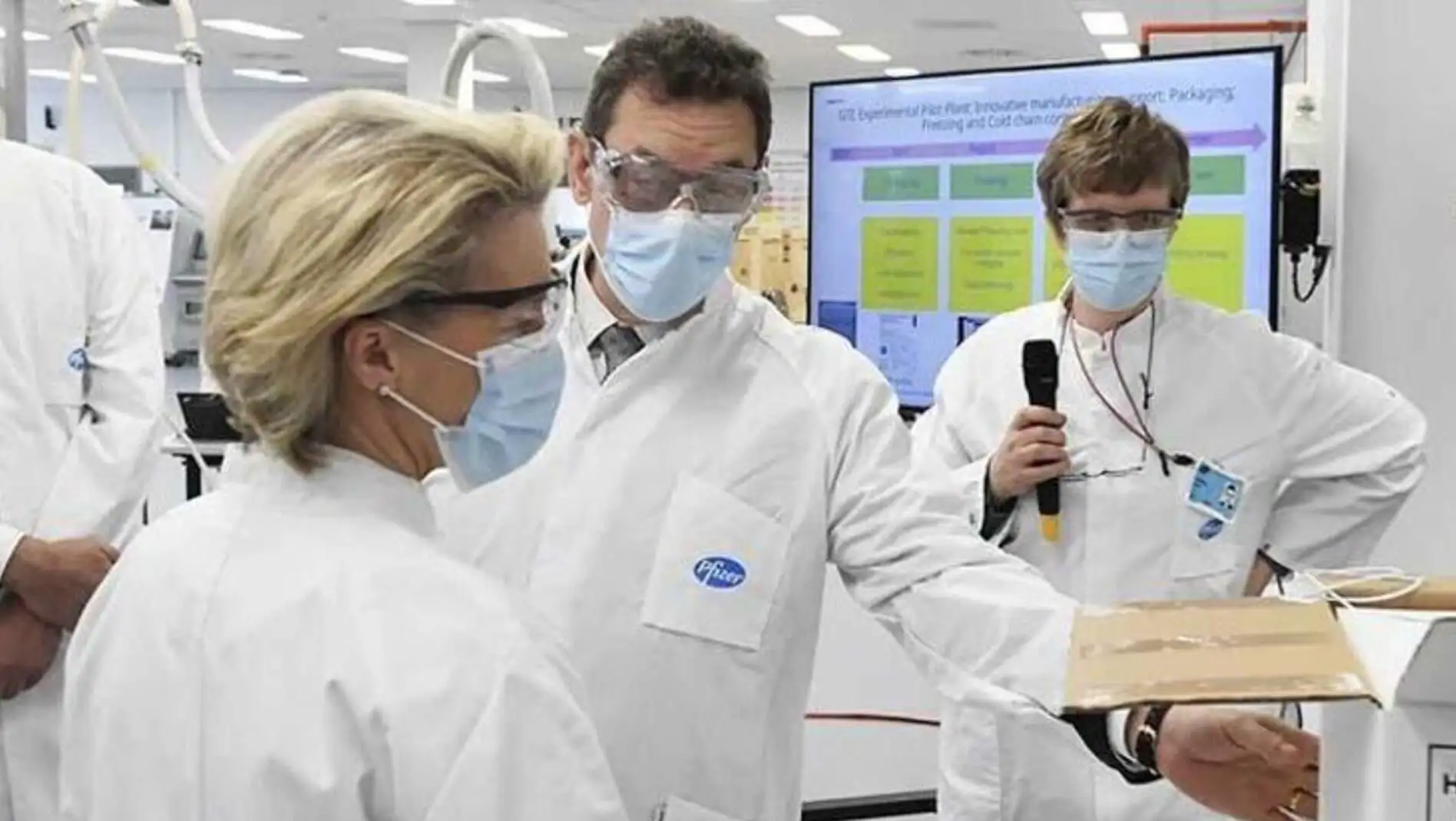 A group of people wearing masks and white coats. A group of people wearing masks and white coats.
