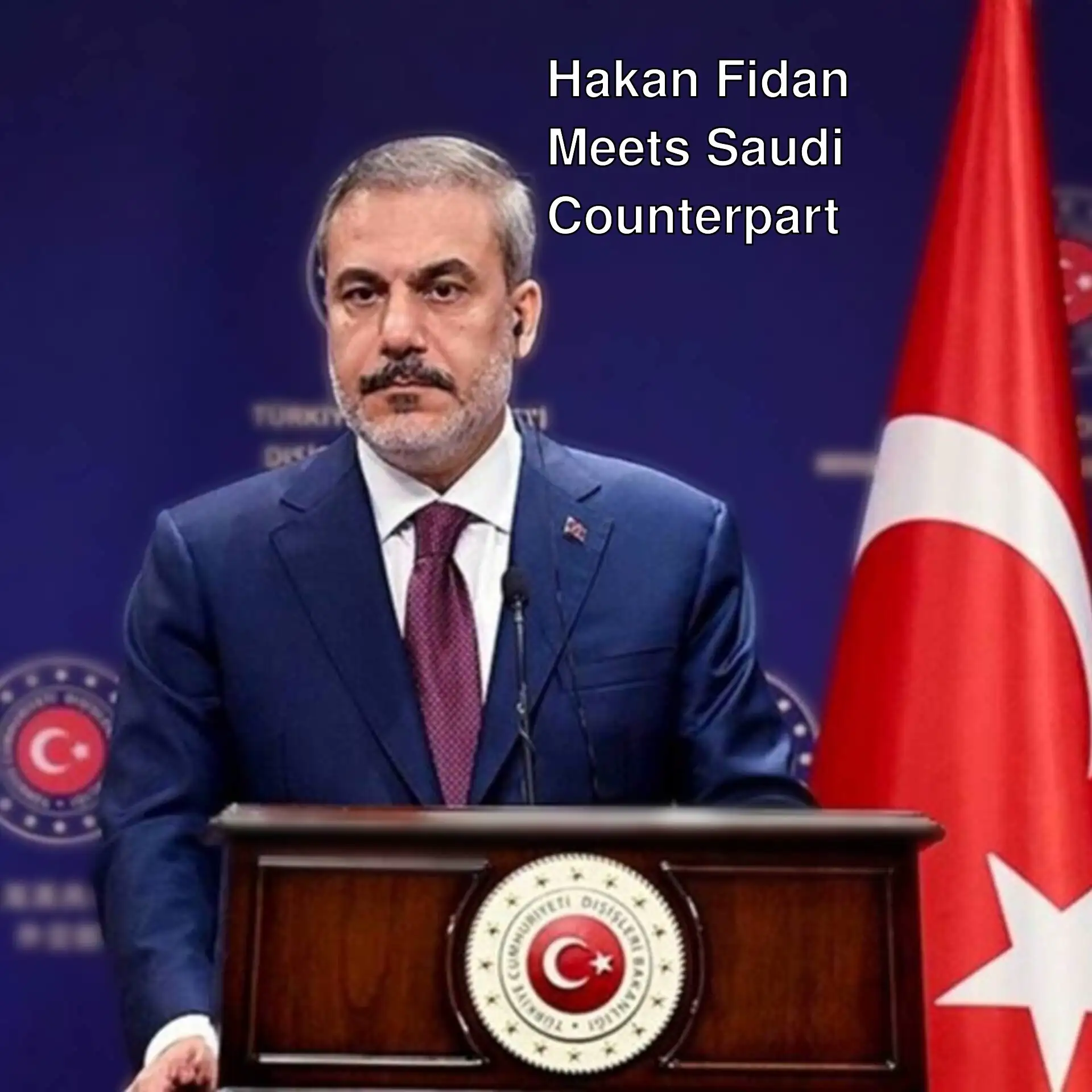 Foreign Minister Hakan Fidan standing at a podium. Foreign Minister Hakan Fidan standing at a podium.