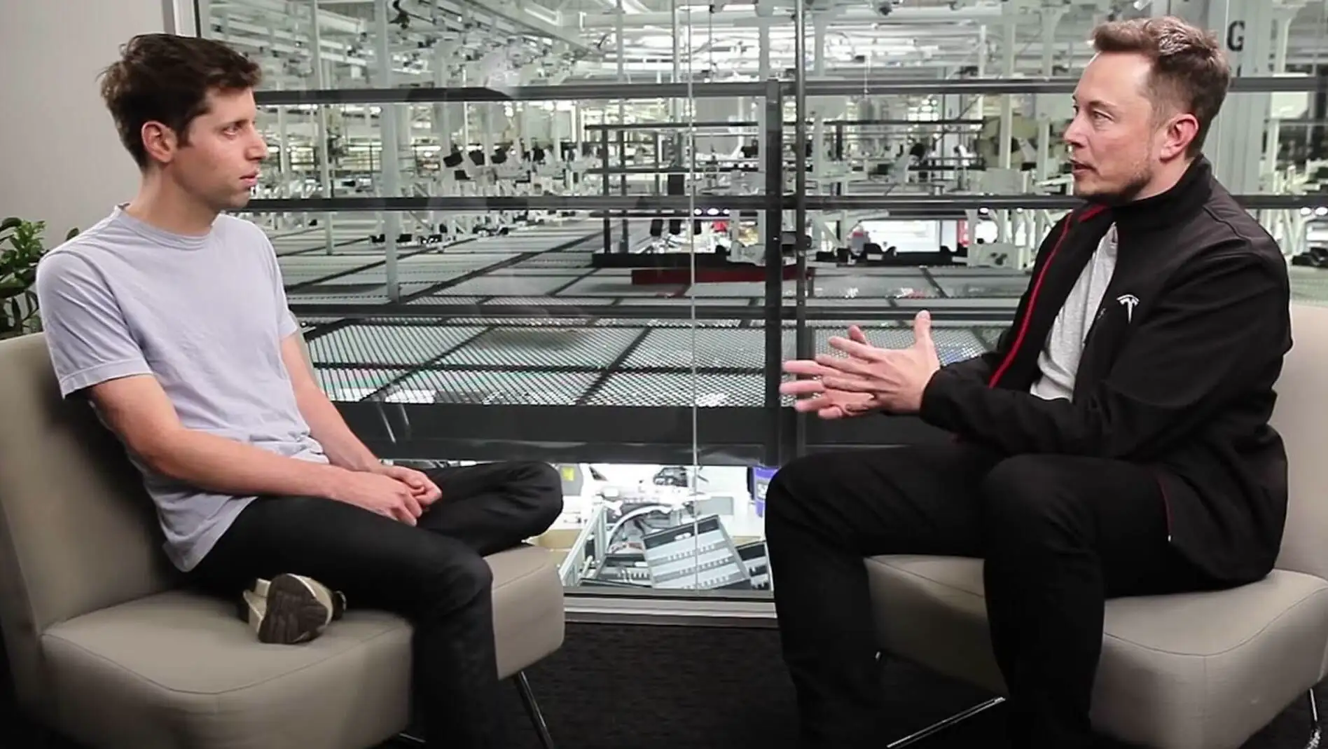 Two men sitting together. The discussion between Elon Musk and Sam Altman continues. Two men sitting together. The discussion between Elon Musk and Sam Altman continues.