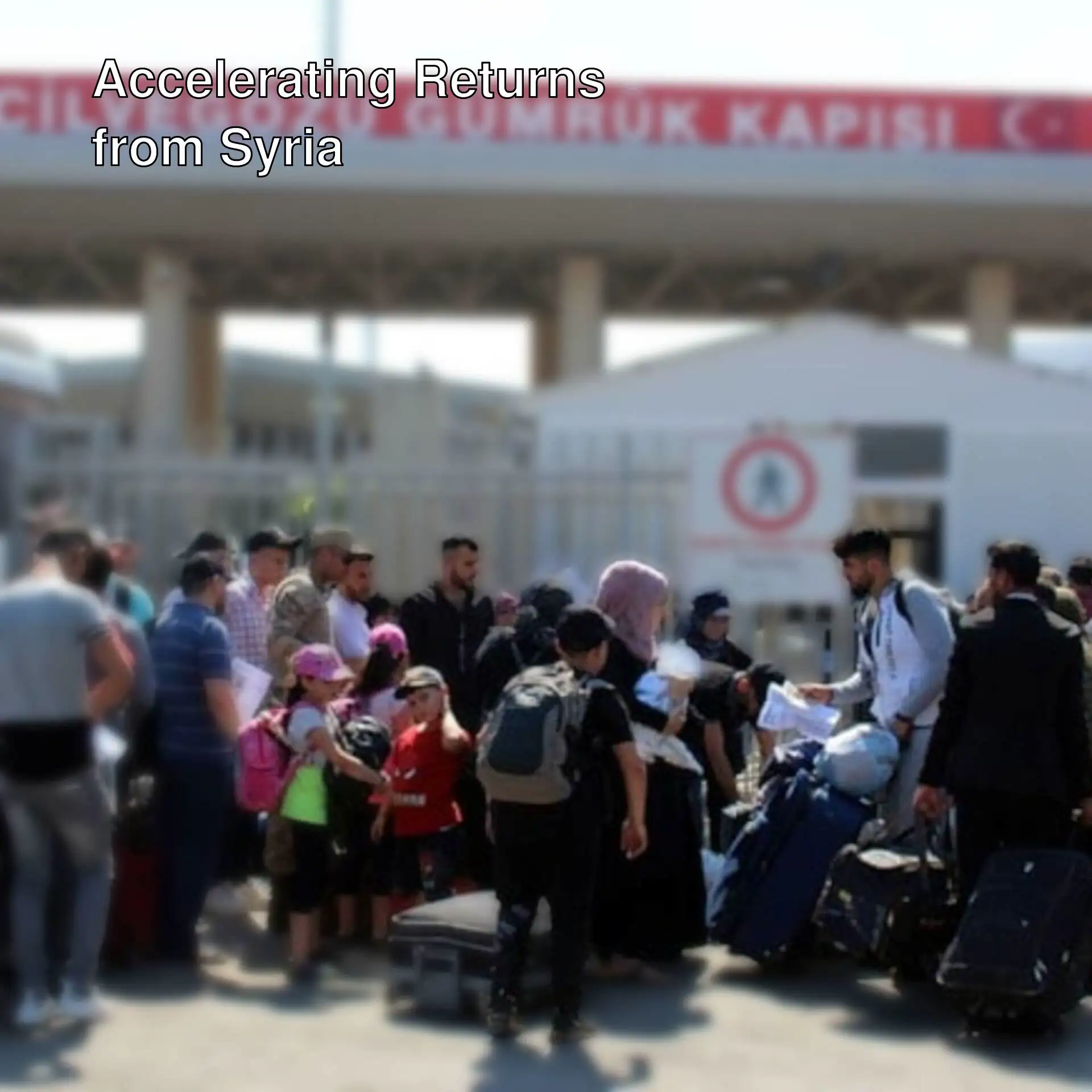 Refugees returning to Syria standing in front of a gate. Refugees returning to Syria standing in front of a gate.