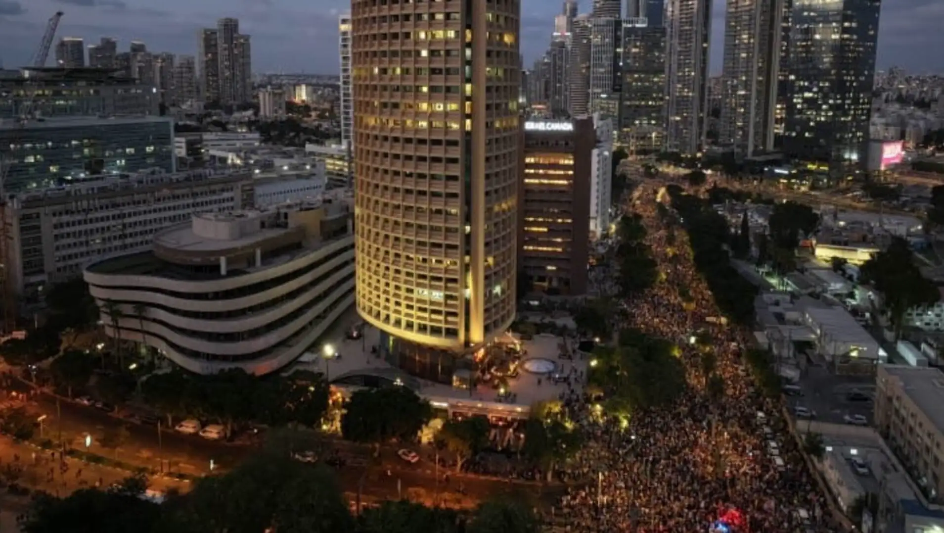 A large crowd walking in the streets of Israel during protests. A large crowd walking in the streets of Israel during protests.