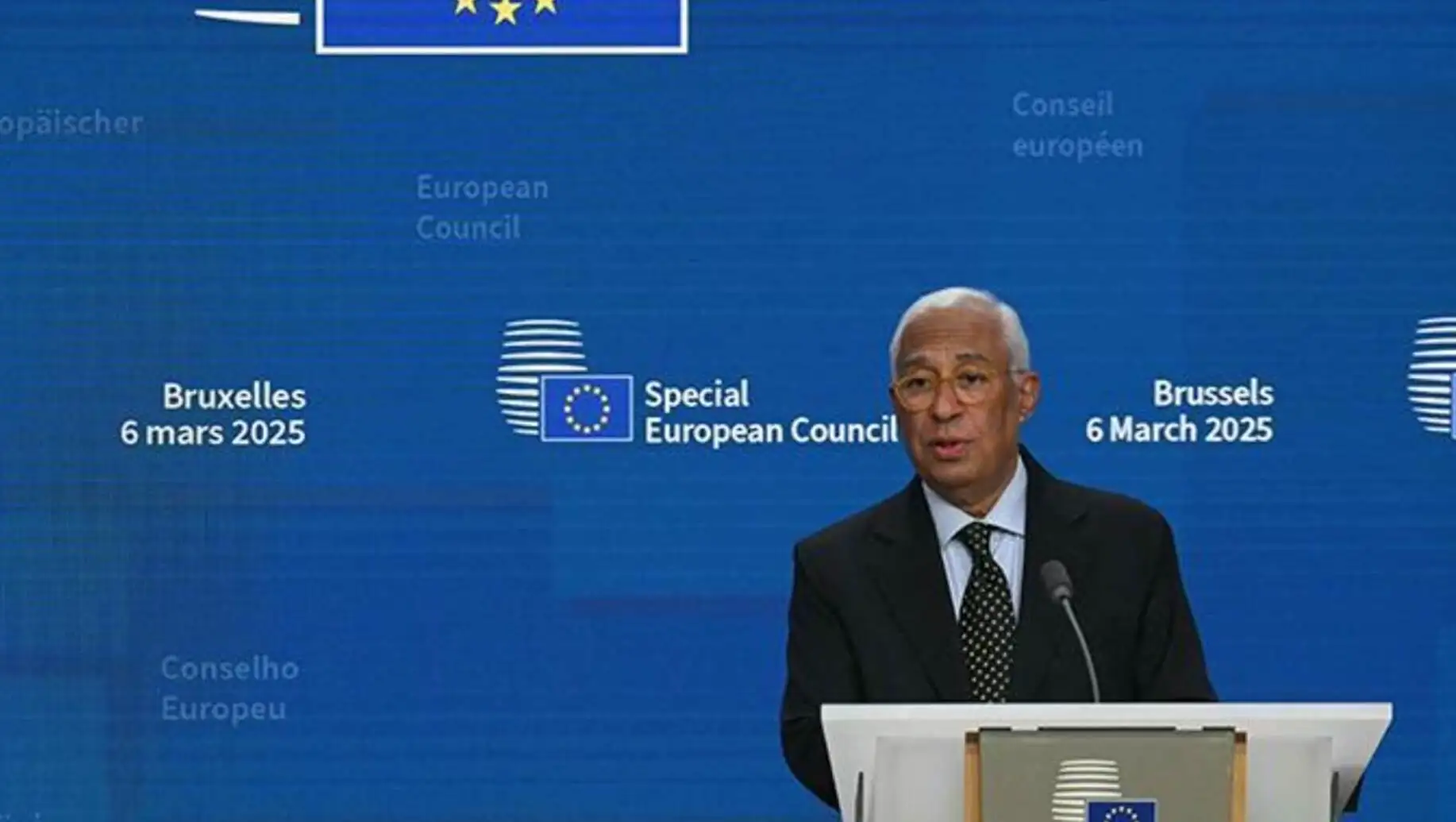 A man standing at a podium. A man standing at a podium.