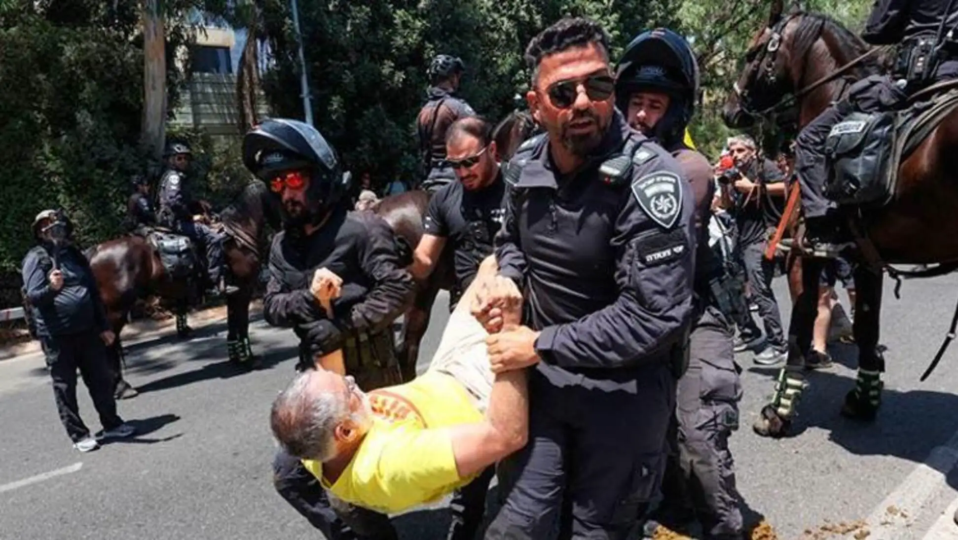 A man being held by police officers. A man being held by police officers.