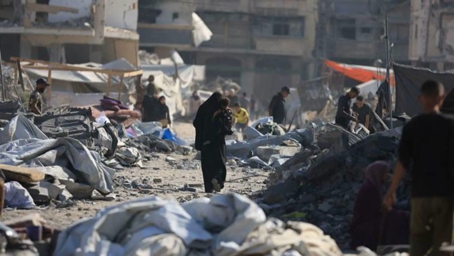 A group of people in a destroyed area. A group of people in a destroyed area.