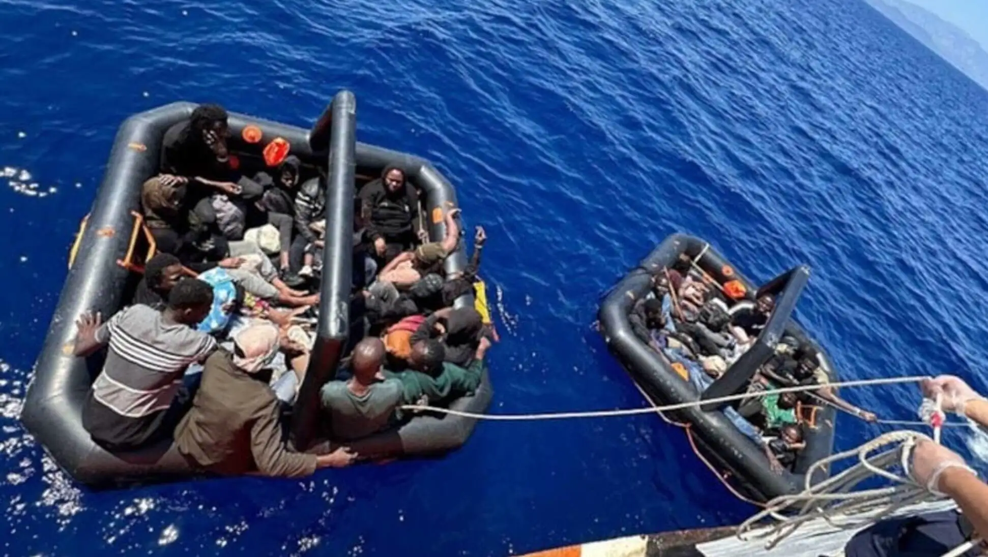 Migrants on a raft in the Aegean Sea. Migrants on a raft in the Aegean Sea.