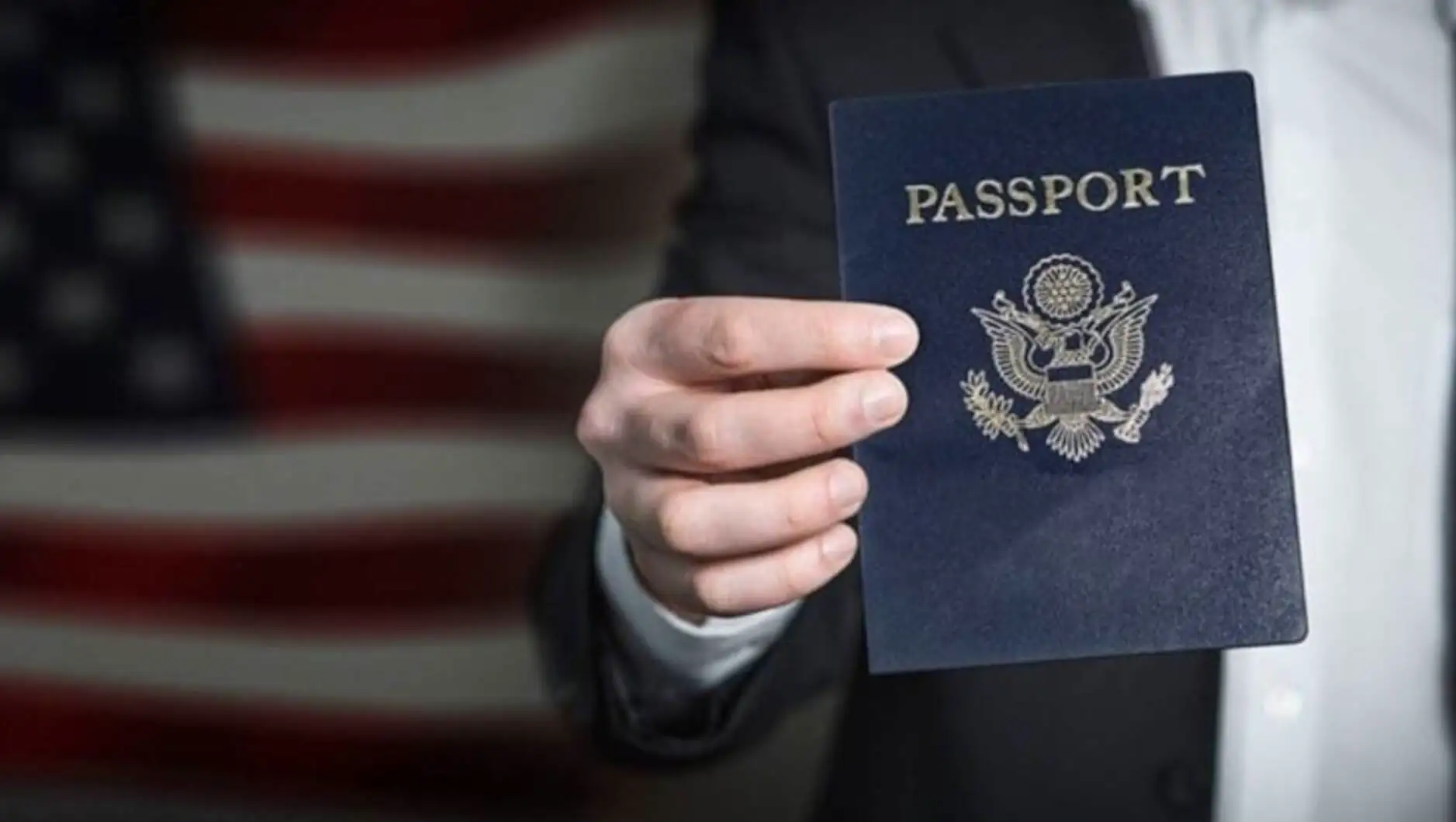 A hand holding a passport. A hand holding a passport.