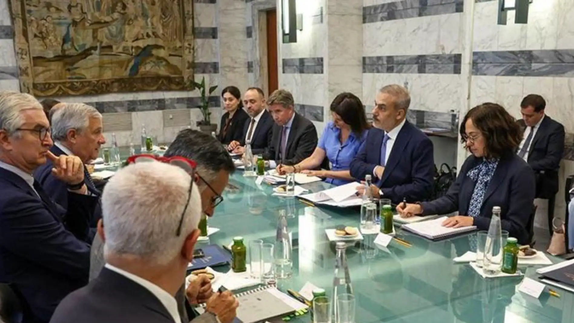 A group of people sitting around a table. A group of people sitting around a table.