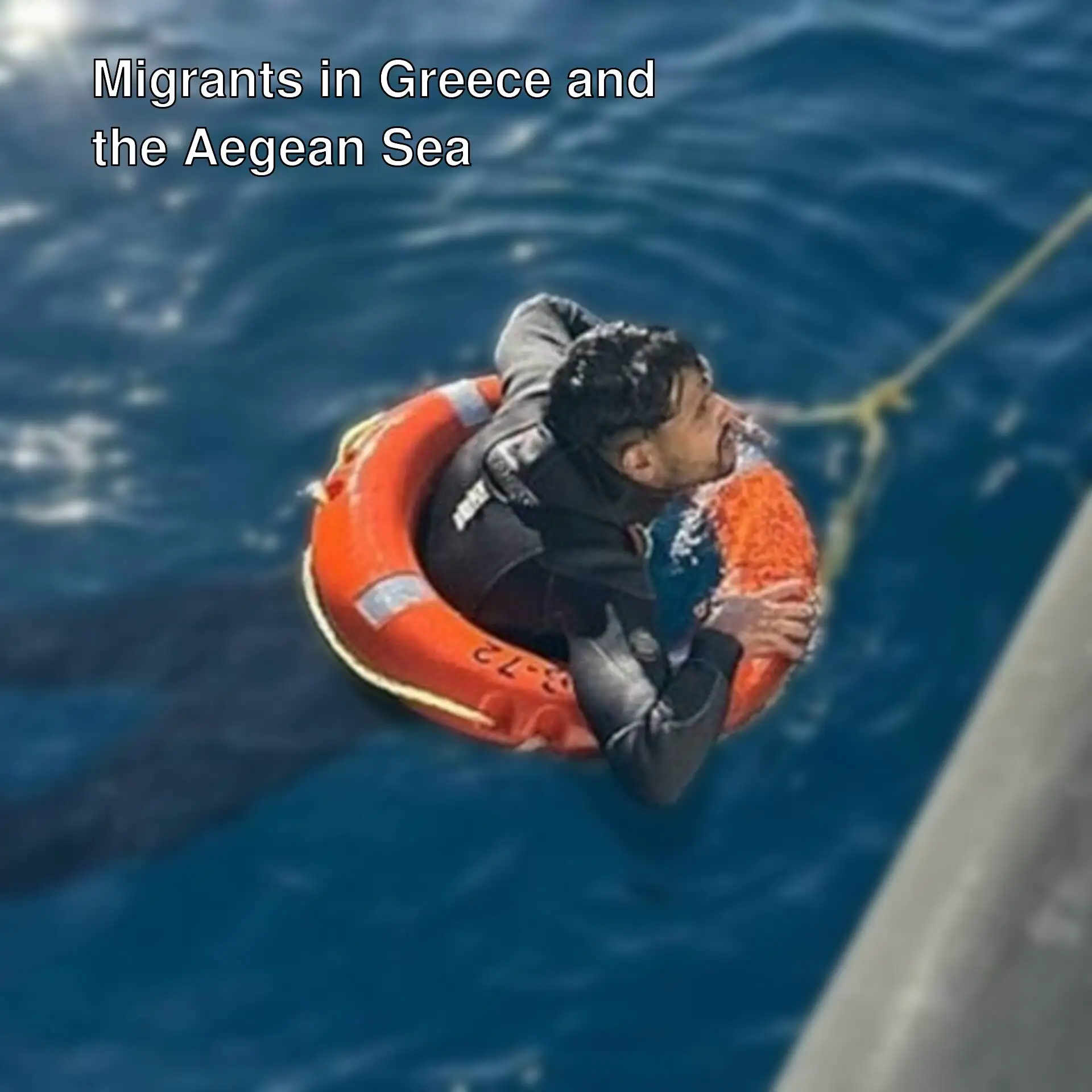 A man in a life preserver in the water.
