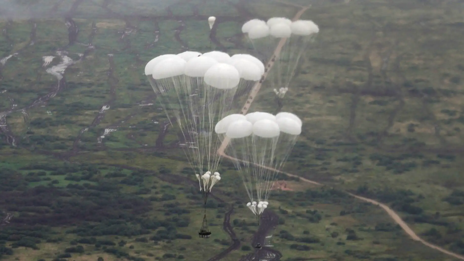 A group of parachutes in the sky. A group of parachutes in the sky.